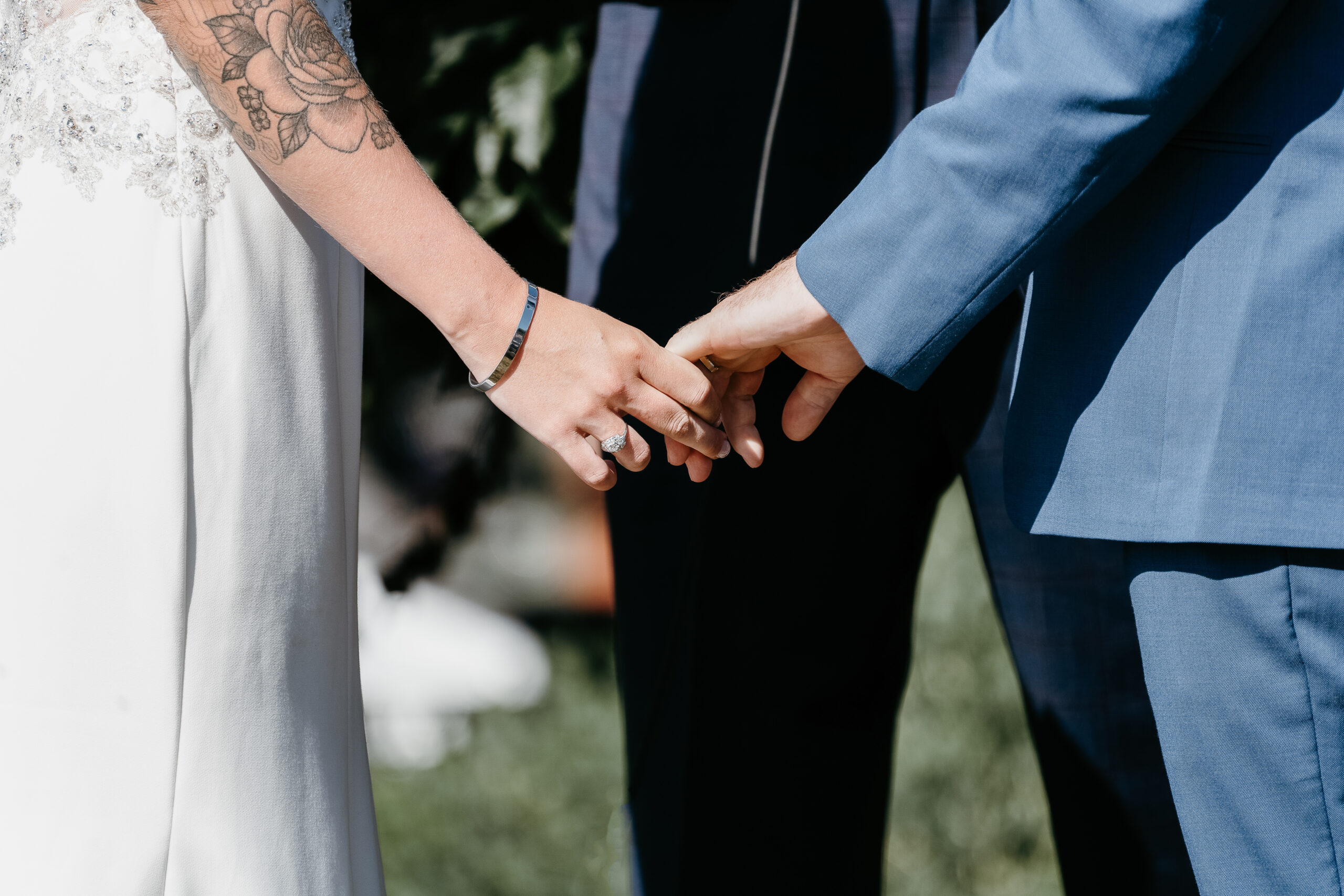 Couple holding hands at wedding