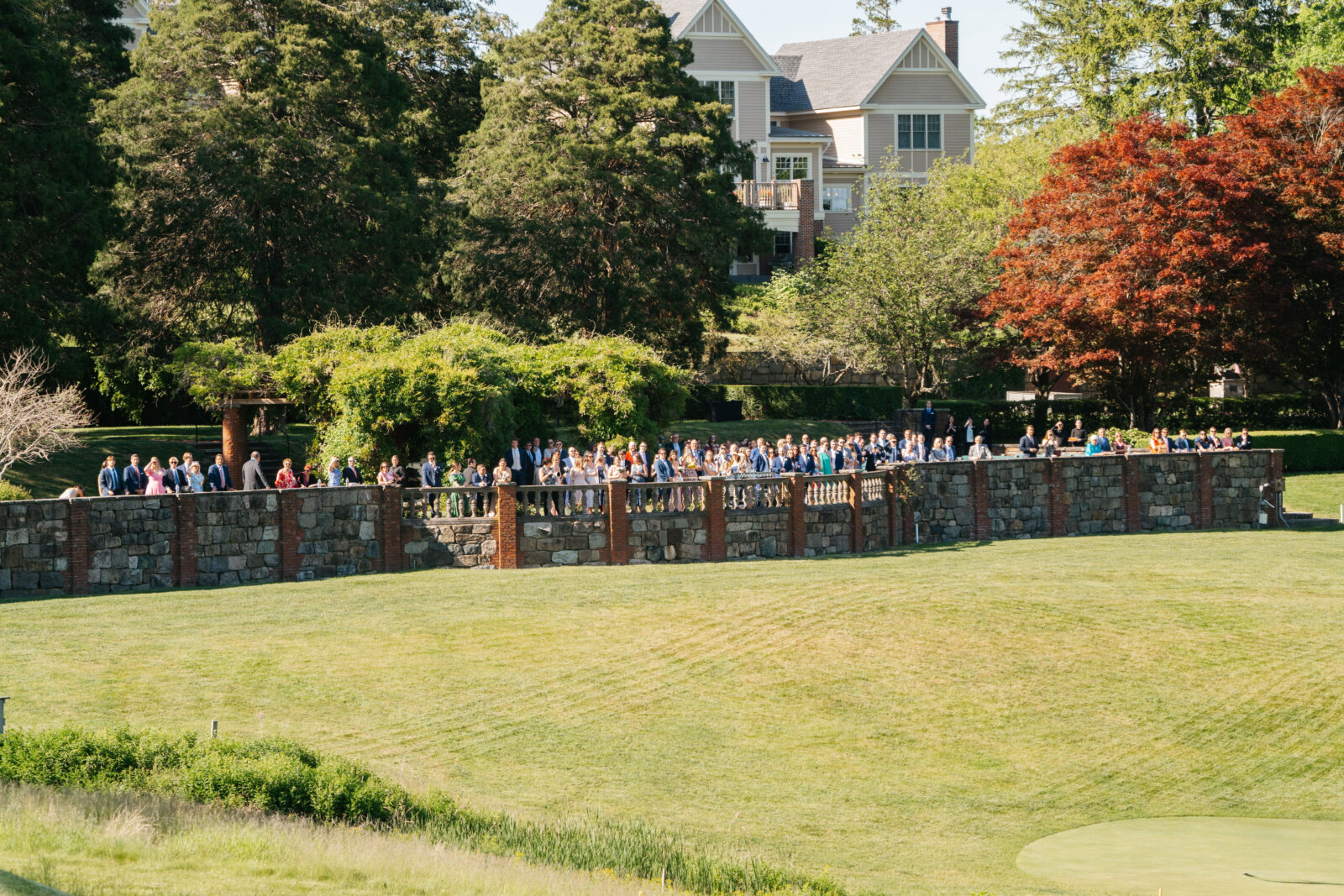 
A special moment as Alix and Wiley tee off together at the 10th hole of Turner Hill, just after their ceremony. Surrounded by family and friends watching from the ceremony site, this unique moment reflects their love for the club and adds a personal touch to their wedding day.