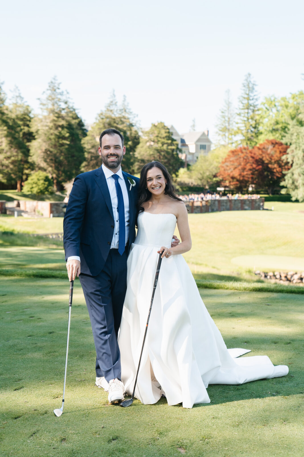 
A special moment as Alix and Wiley tee off together at the 10th hole of Turner Hill, just after their ceremony. Surrounded by family and friends watching from the ceremony site, this unique moment reflects their love for the club and adds a personal touch to their wedding day.