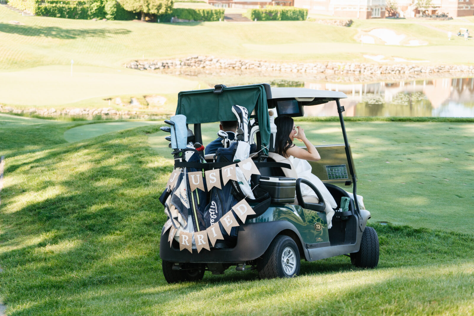 
A special moment as Alix and Wiley tee off together at the 10th hole of Turner Hill, just after their ceremony. Surrounded by family and friends watching from the ceremony site, this unique moment reflects their love for the club and adds a personal touch to their wedding day.