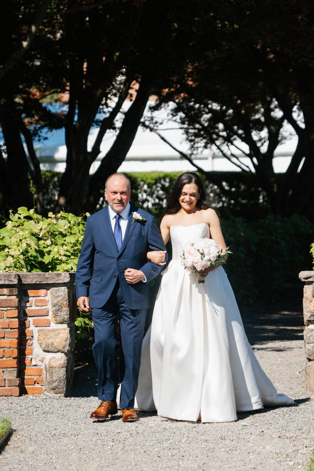 
A beautiful and emotional moment during Alix and Wiley’s outdoor ceremony at Turner Hill, as they exchange vows surrounded by lush greenery and their loved ones. The love and joy shared between the couple is evident, making this a truly unforgettable moment in their celebration.