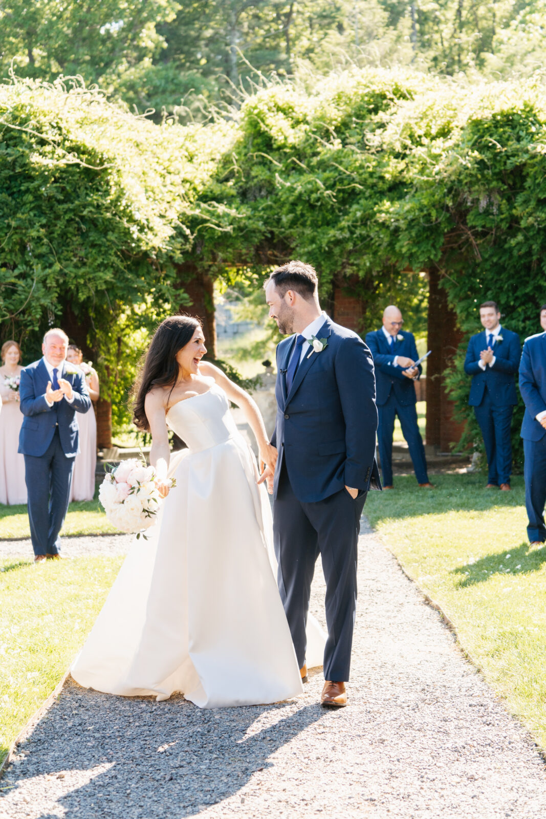 
A beautiful and emotional moment during Alix and Wiley’s outdoor ceremony at Turner Hill, as they exchange vows surrounded by lush greenery and their loved ones. The love and joy shared between the couple is evident, making this a truly unforgettable moment in their celebration.