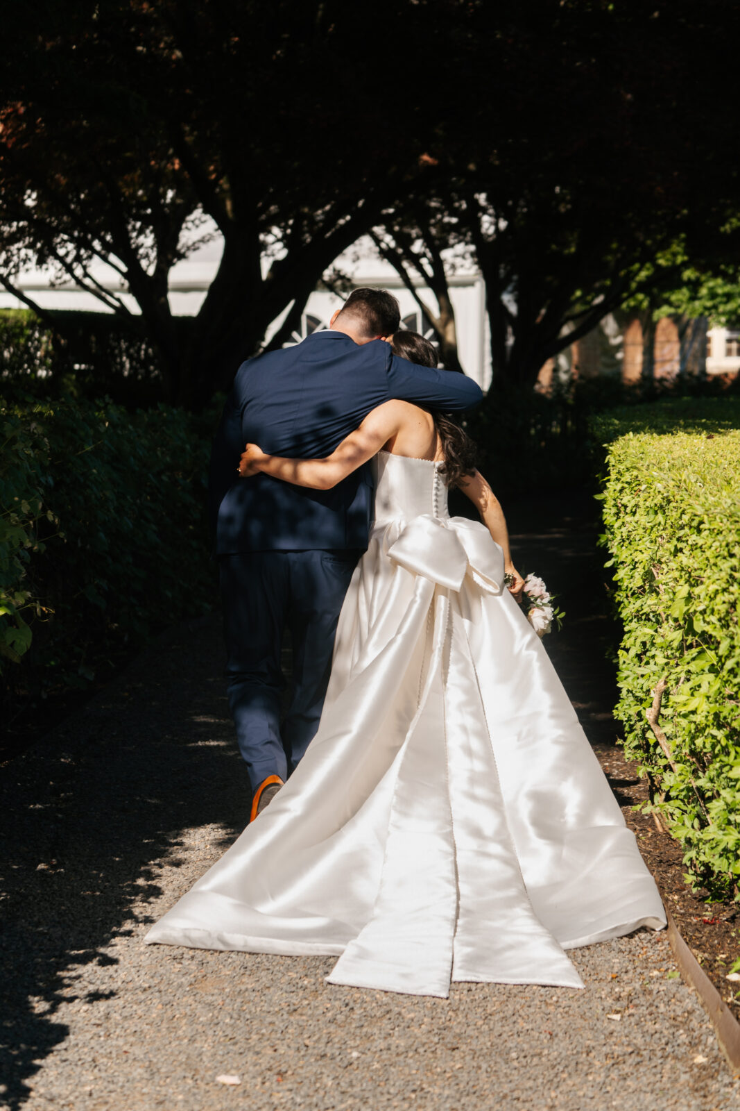 
A beautiful and emotional moment during Alix and Wiley’s outdoor ceremony at Turner Hill, as they exchange vows surrounded by lush greenery and their loved ones. The love and joy shared between the couple is evident, making this a truly unforgettable moment in their celebration.