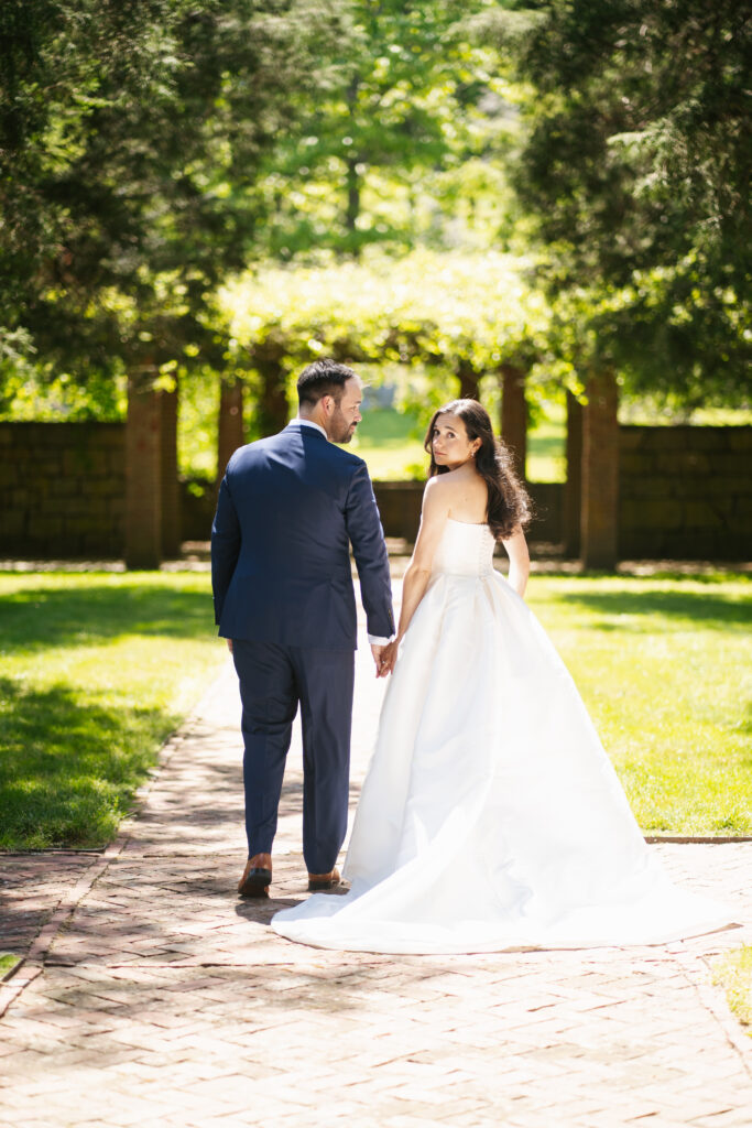 
A vibrant, candid photo of a wedding couple sharing a joyful moment during their celebration, with soft, natural lighting highlighting the colors and emotions of the day. The image captures an authentic, in-between moment that showcases the couple’s connection and the love in the air.