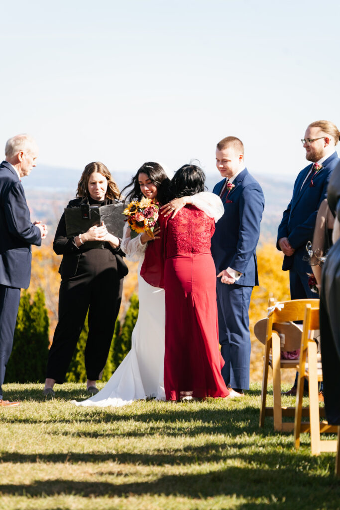 
A vibrant, candid photo of a wedding couple sharing a joyful moment during their celebration, with soft, natural lighting highlighting the colors and emotions of the day. The image captures an authentic, in-between moment that showcases the couple’s connection and the love in the air.