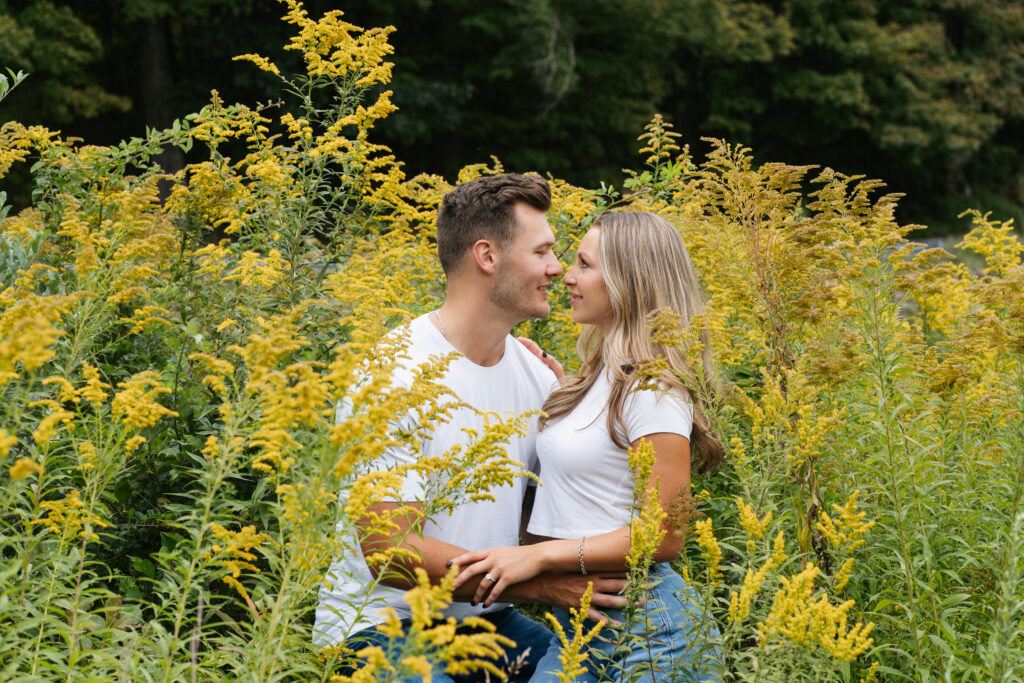 
A vibrant, candid photo of a wedding couple sharing a joyful moment during their celebration, with soft, natural lighting highlighting the colors and emotions of the day. The image captures an authentic, in-between moment that showcases the couple’s connection and the love in the air.