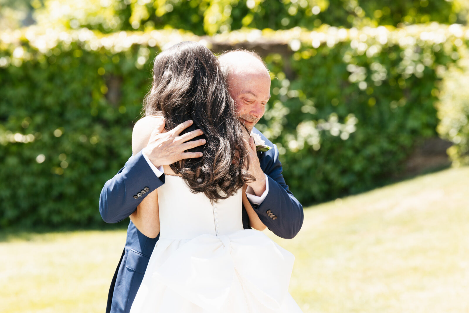 A heartfelt moment as Alix shares a first look with her dad, filled with emotion and love. His face lights up with pride and joy as he sees his daughter in her stunning wedding gown for the first time.