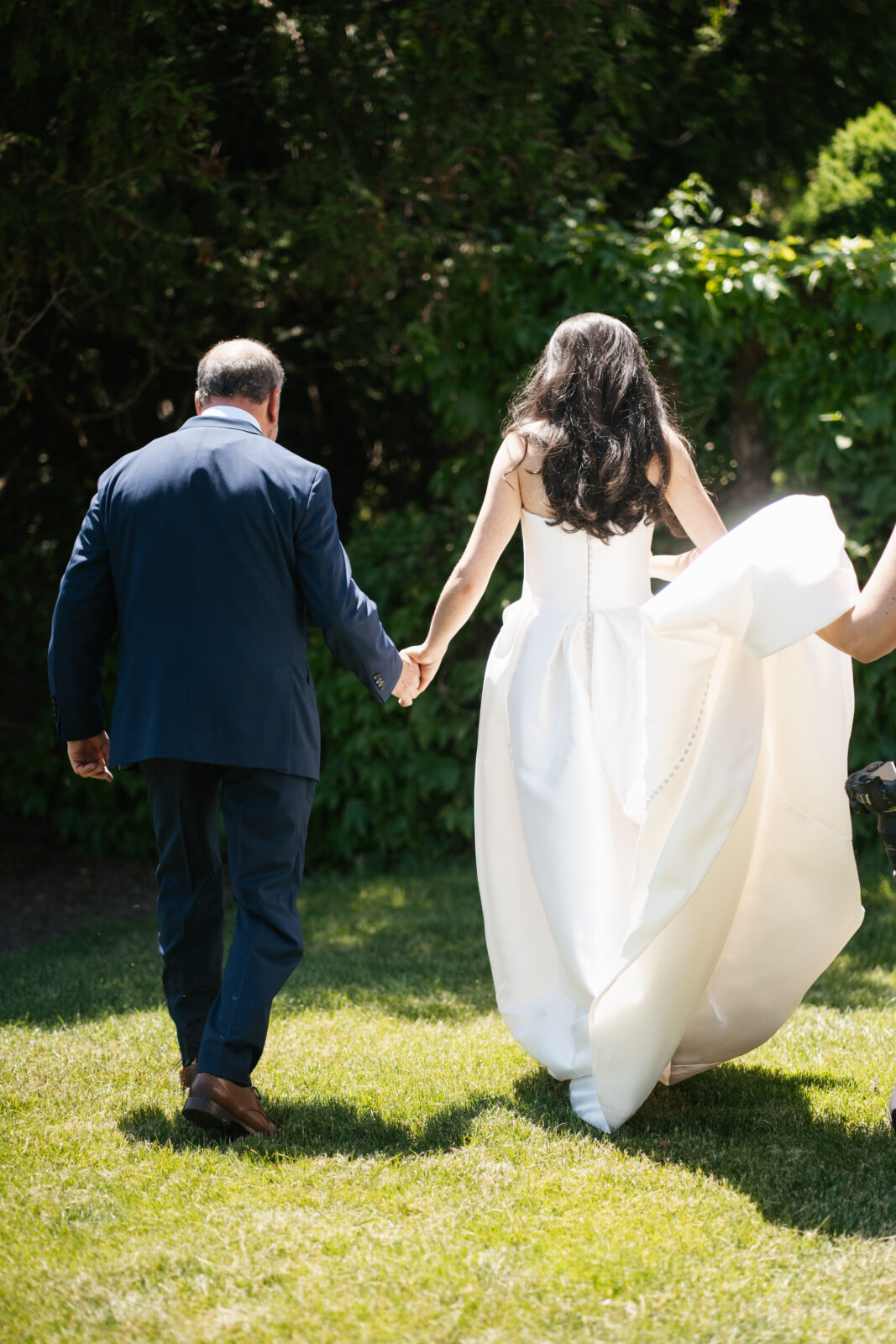 A heartfelt moment as Alix shares a first look with her dad, filled with emotion and love. His face lights up with pride and joy as he sees his daughter in her stunning wedding gown for the first time.