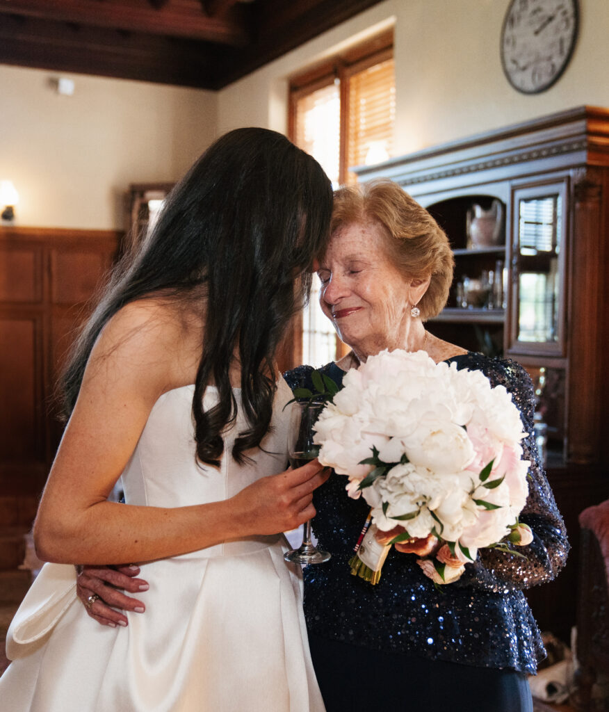 
A vibrant, candid photo of a wedding couple sharing a joyful moment during their celebration, with soft, natural lighting highlighting the colors and emotions of the day. The image captures an authentic, in-between moment that showcases the couple’s connection and the love in the air.