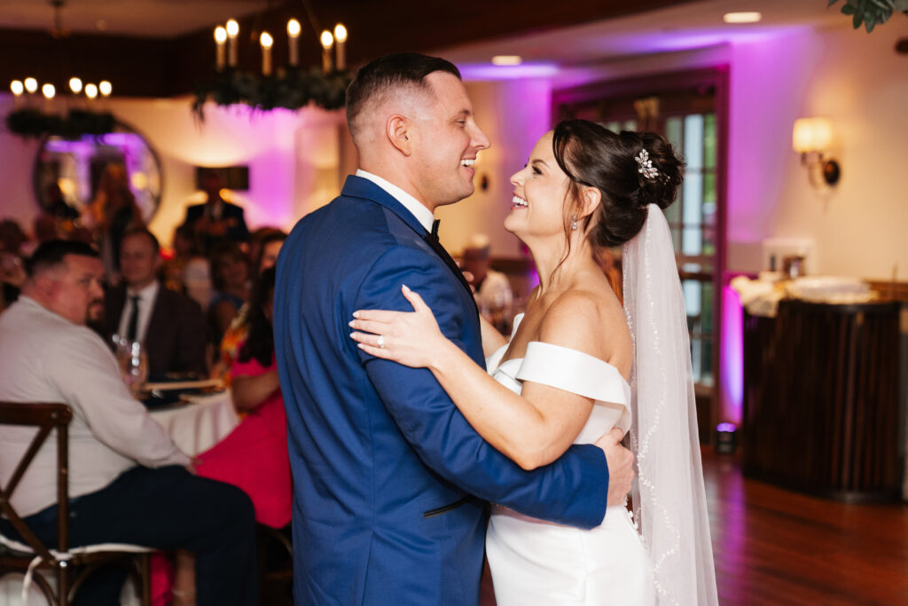 
A vibrant, candid photo of a wedding couple sharing a joyful moment during their celebration, with soft, natural lighting highlighting the colors and emotions of the day. The image captures an authentic, in-between moment that showcases the couple’s connection and the love in the air.