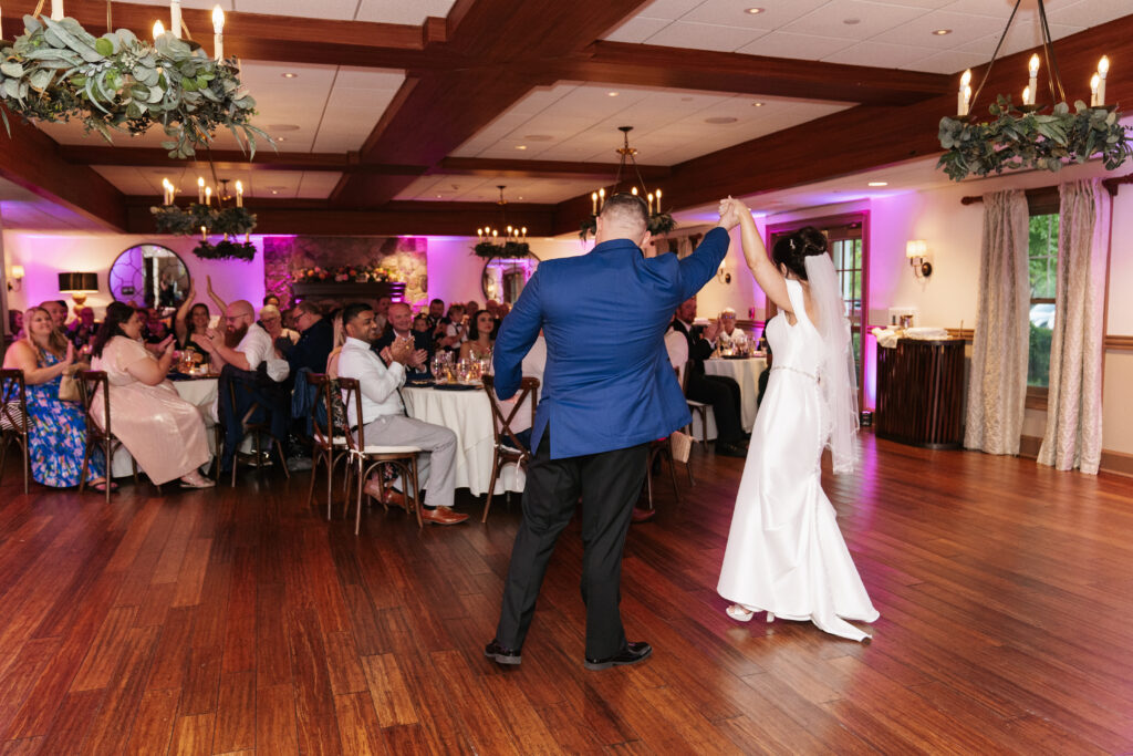 
A vibrant, candid photo of a wedding couple sharing a joyful moment during their celebration, with soft, natural lighting highlighting the colors and emotions of the day. The image captures an authentic, in-between moment that showcases the couple’s connection and the love in the air.