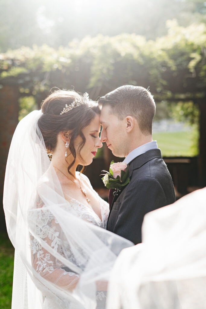 
A vibrant, candid photo of a wedding couple sharing a joyful moment during their celebration, with soft, natural lighting highlighting the colors and emotions of the day. The image captures an authentic, in-between moment that showcases the couple’s connection and the love in the air.