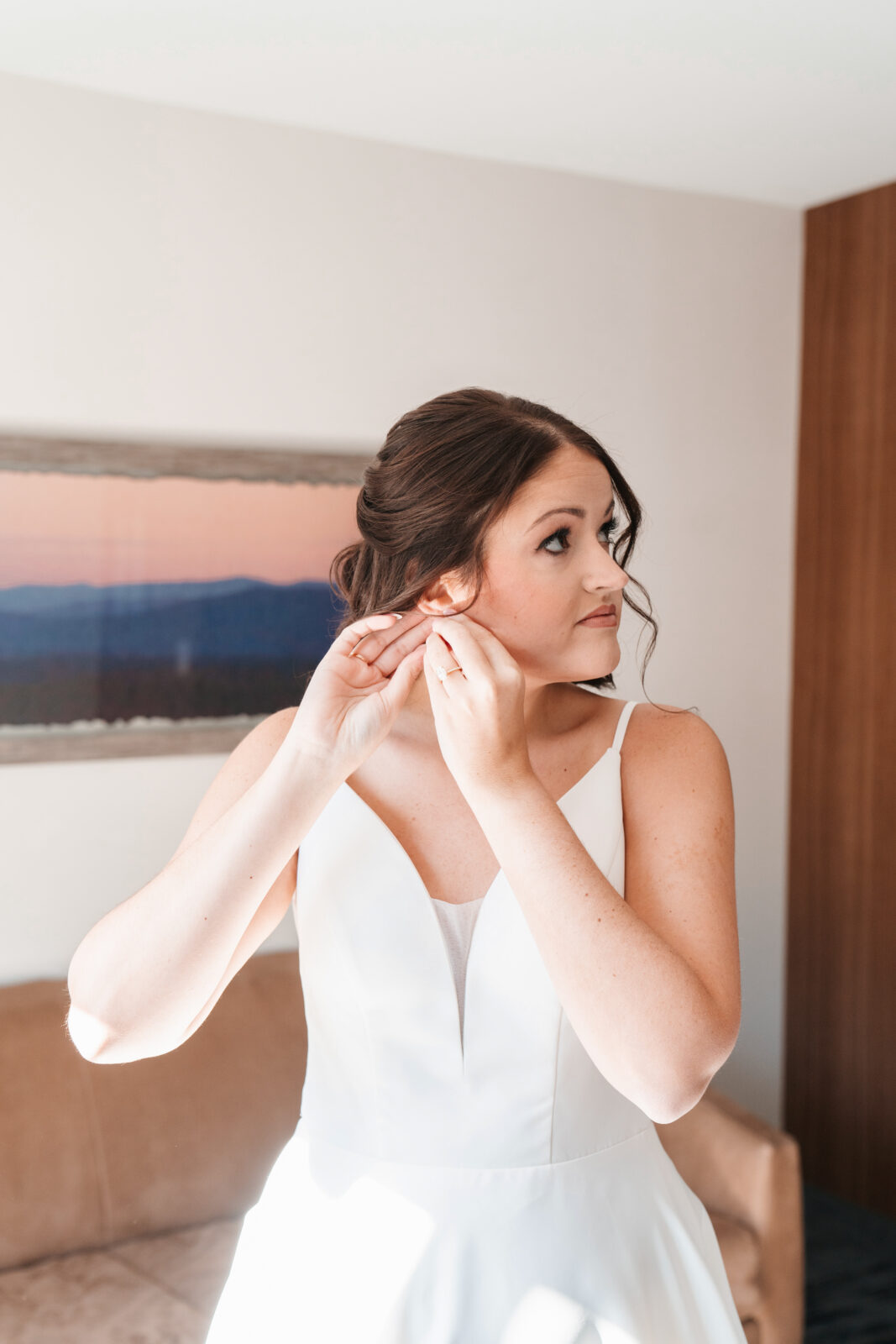 Bride getting ready in the bridal suite at Waverly Oaks in Plymouth, MA, surrounded by natural light and soft, elegant details.
