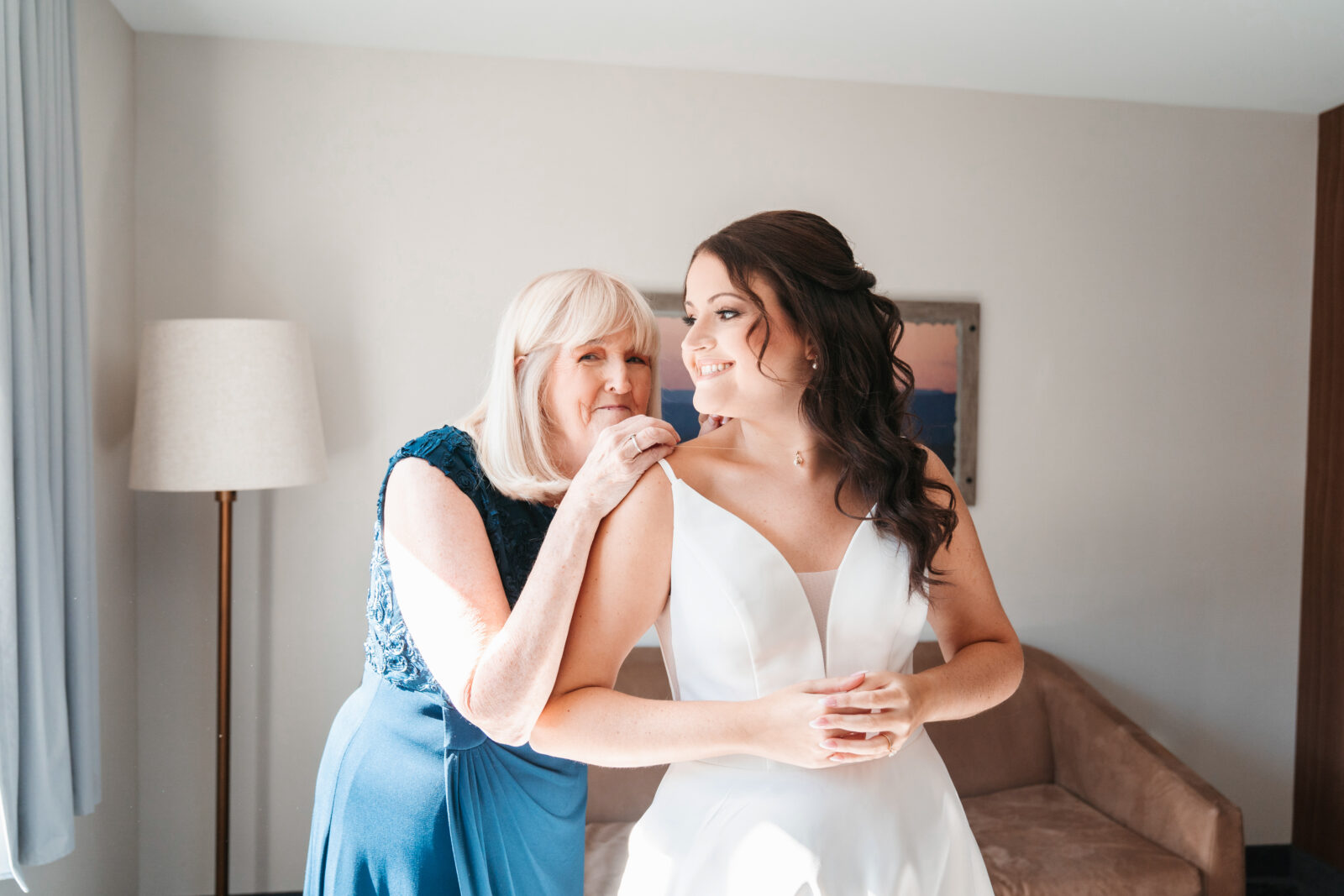 Bride getting ready in the bridal suite at Waverly Oaks in Plymouth, MA, surrounded by natural light and soft, elegant details.