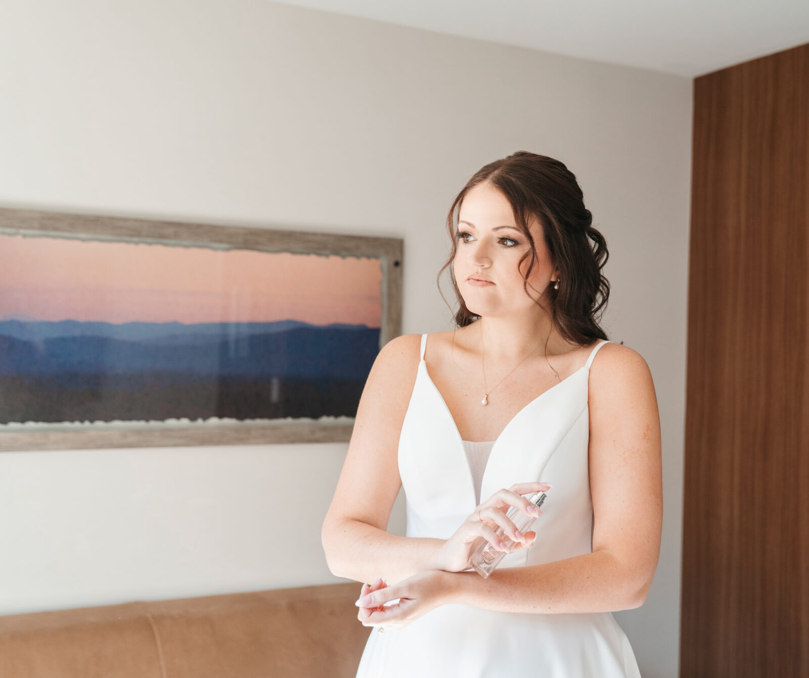 Bride getting ready in the bridal suite at Waverly Oaks in Plymouth, MA, surrounded by natural light and soft, elegant details.