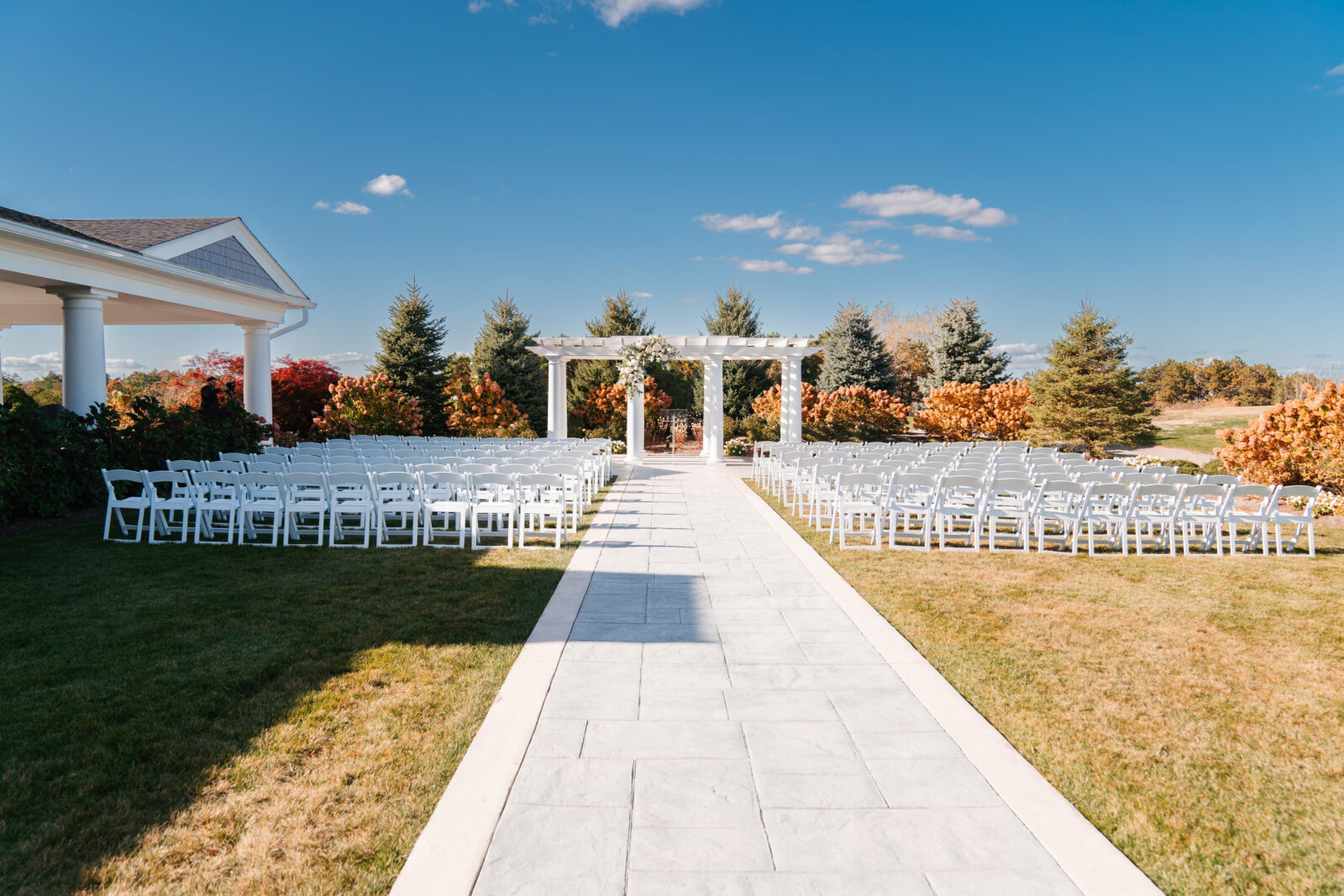 Elegant wedding flat lay with invitation suite, rings, and florals styled on soft linen at Waverly Oaks in Plymouth, MA.