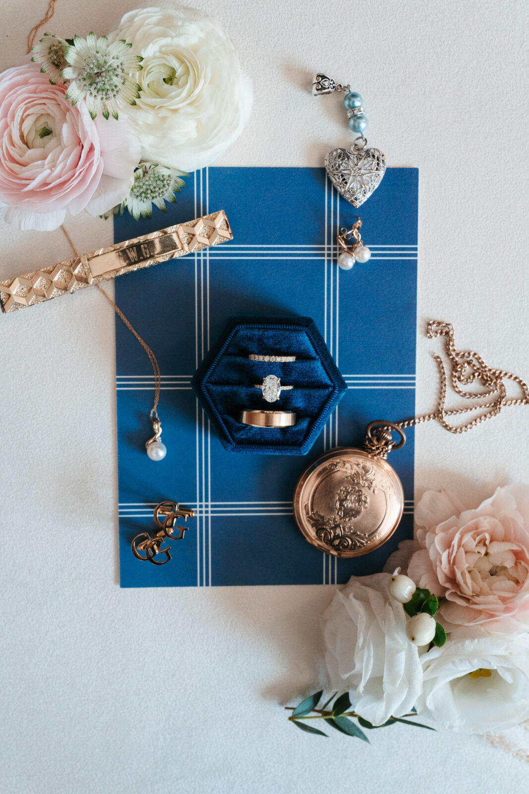 Elegant wedding flat lay with invitation suite, rings, and florals styled on soft linen at Waverly Oaks in Plymouth, MA.