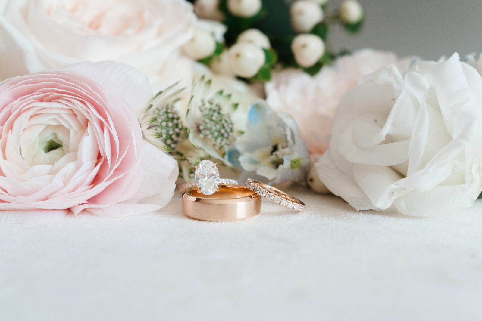 Elegant wedding flat lay with invitation suite, rings, and florals styled on soft linen at Waverly Oaks in Plymouth, MA.