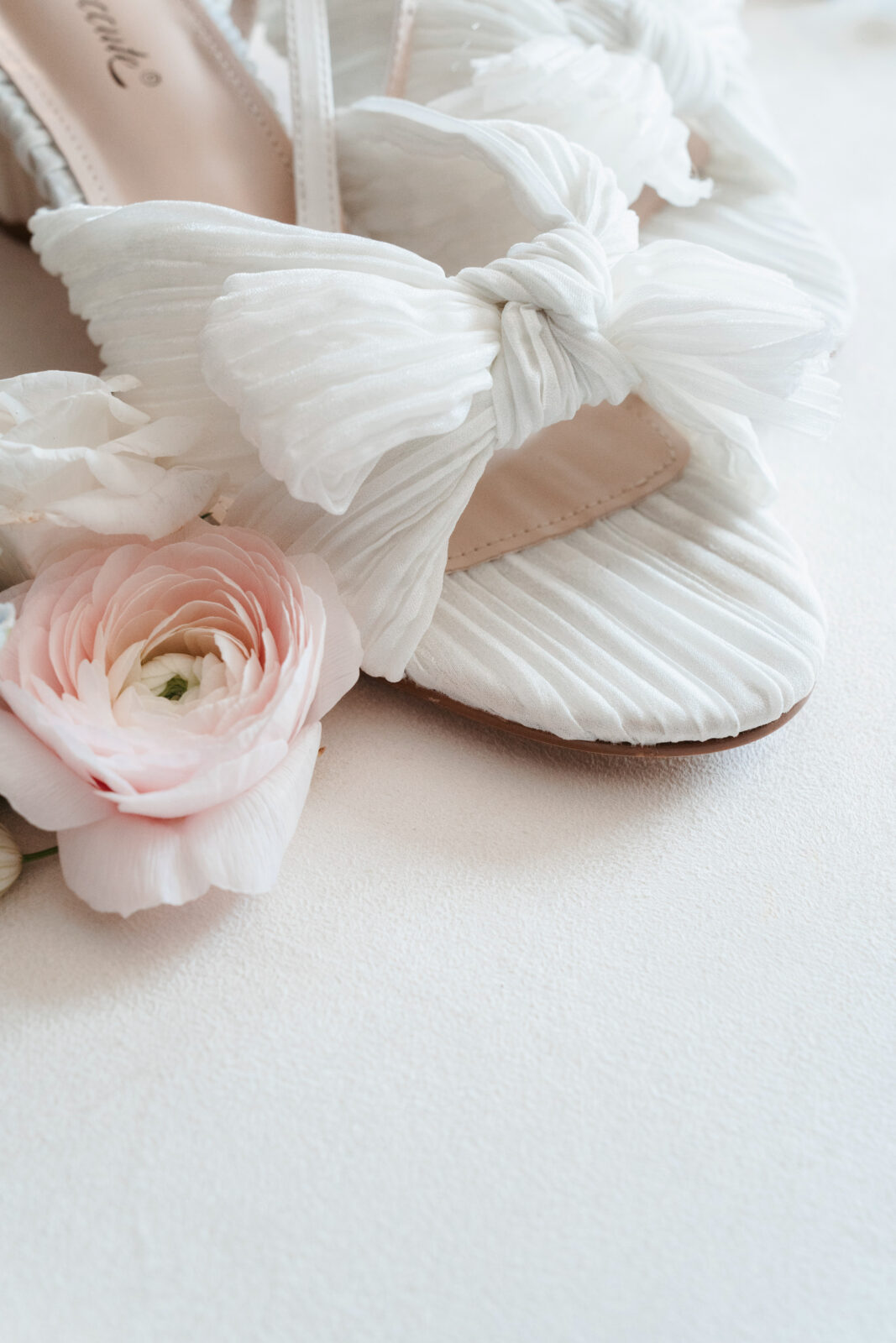 Elegant wedding flat lay with invitation suite, rings, and florals styled on soft linen at Waverly Oaks in Plymouth, MA.