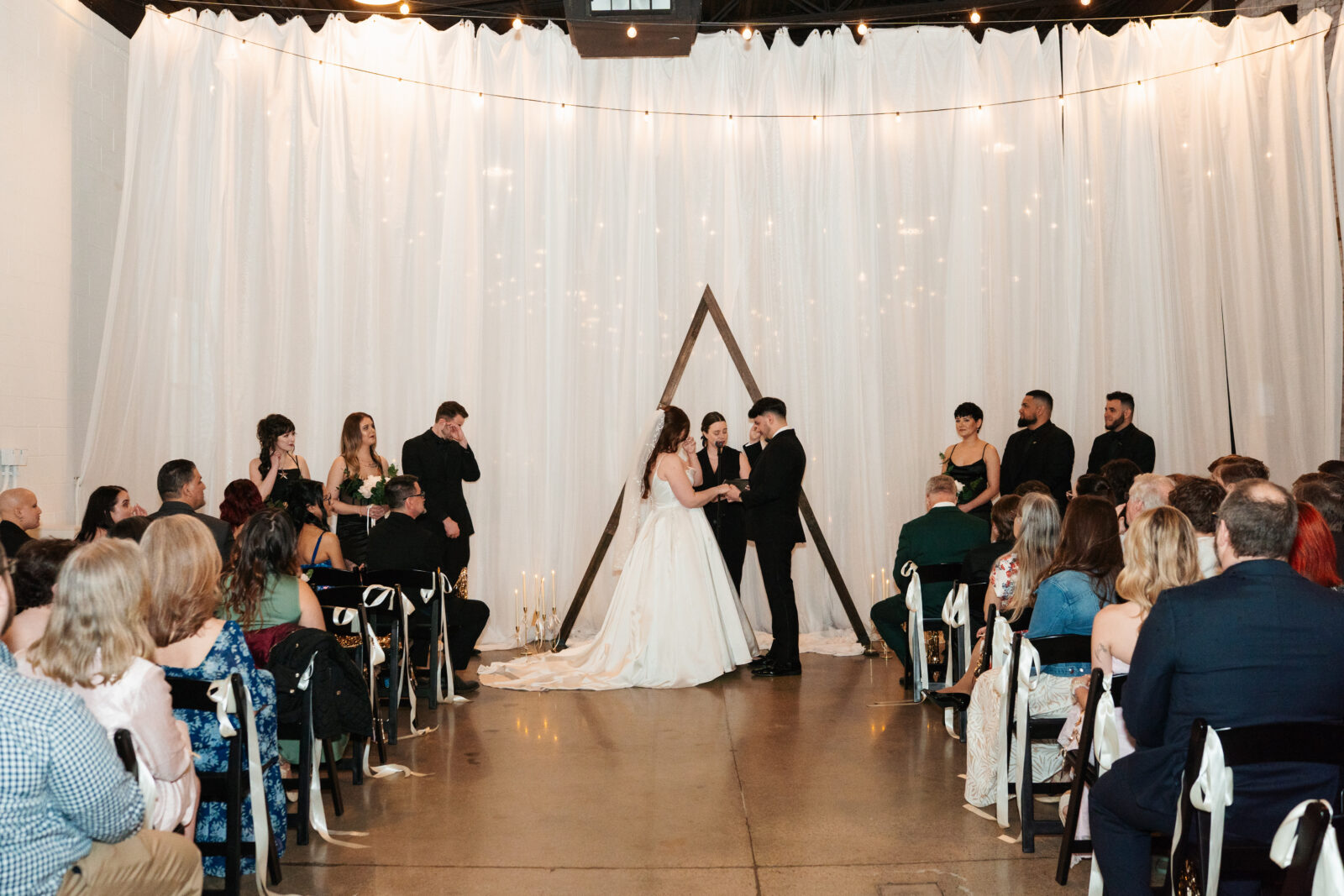 Couple exchanging vows with Disney-themed details during their wedding ceremony.
