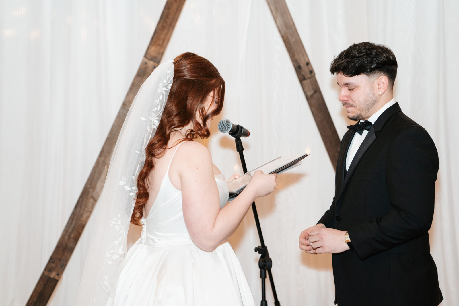 Couple exchanging vows with Disney-themed details during their wedding ceremony.