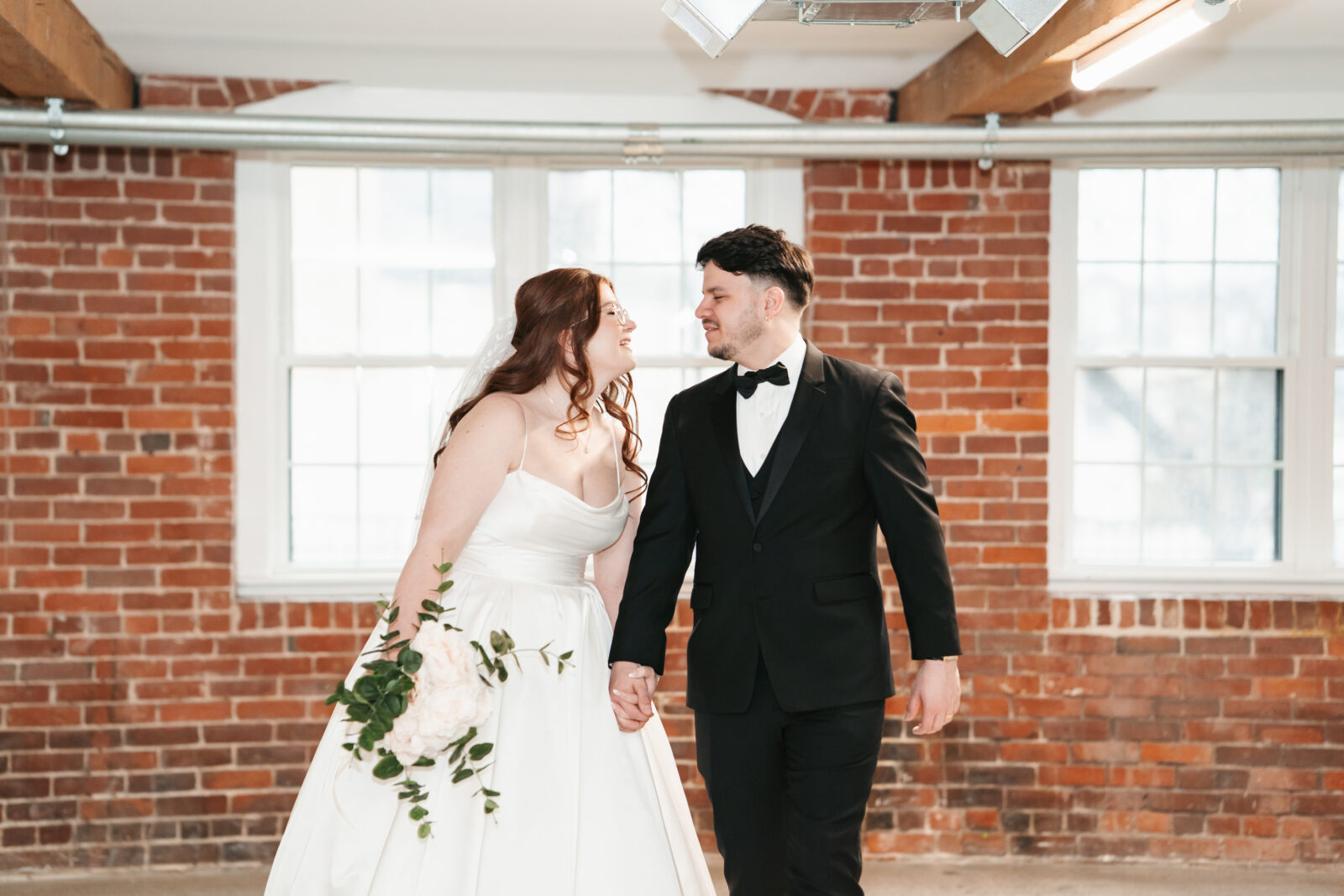 Industrial-chic wedding portraits of Emily and Nate inside The Venues at the Factory.