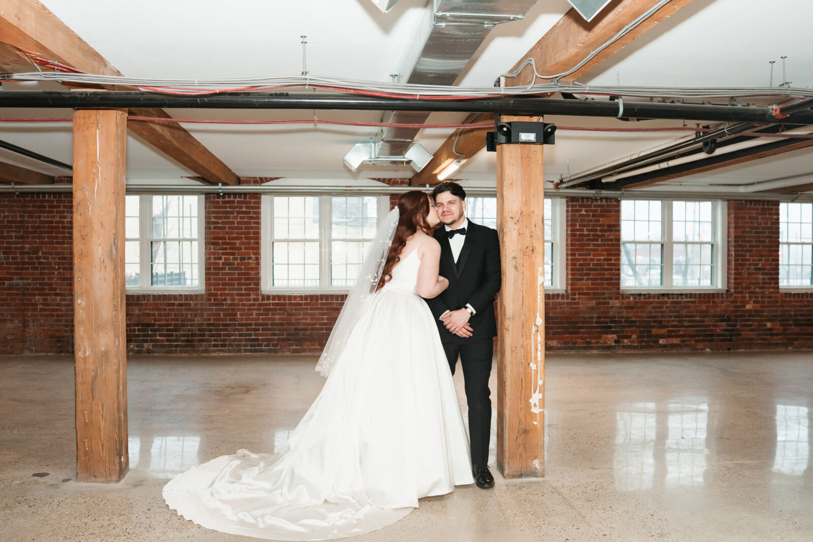 Industrial-chic wedding portraits of Emily and Nate inside The Venues at the Factory.