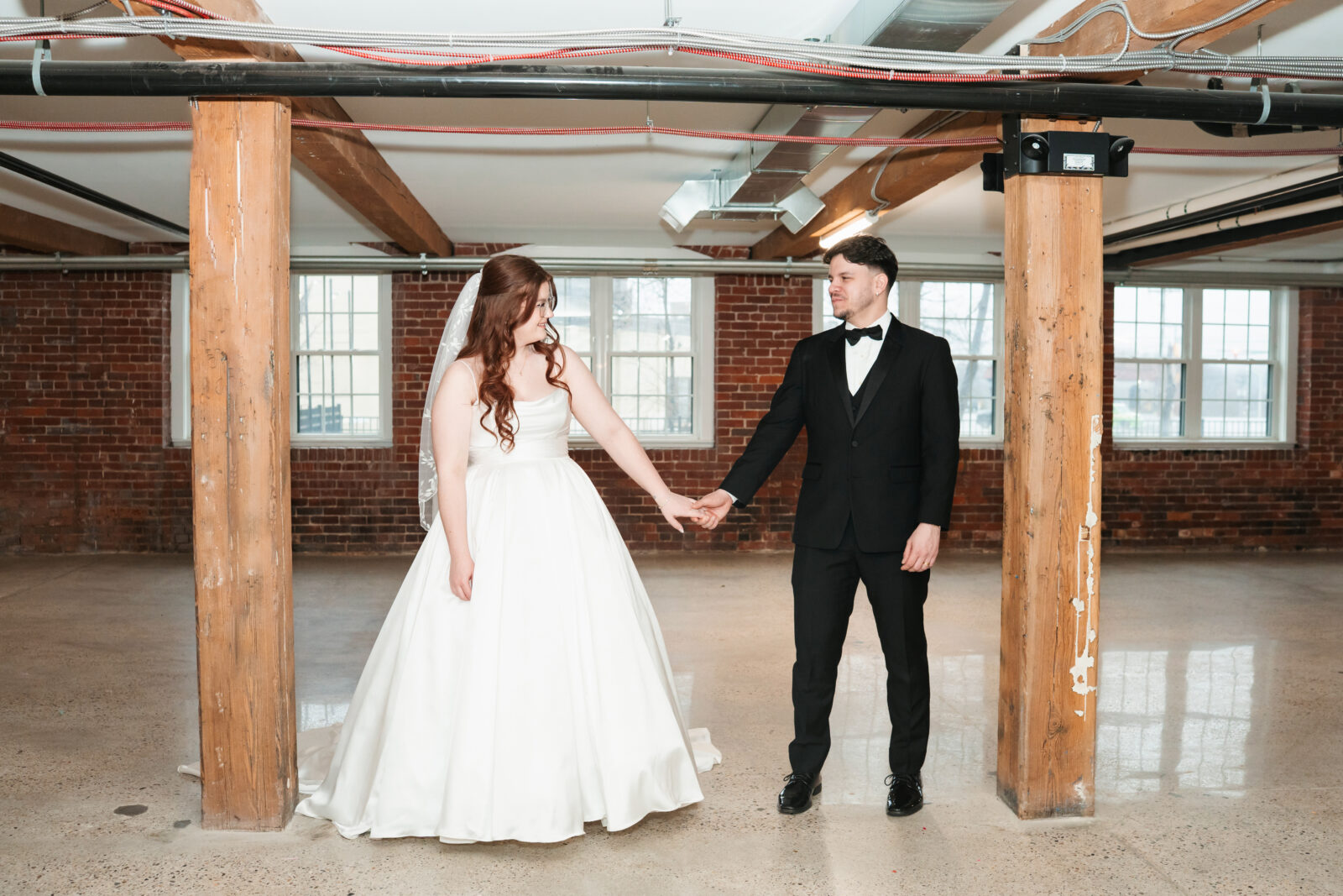 Industrial-chic wedding portraits of Emily and Nate inside The Venues at the Factory.
