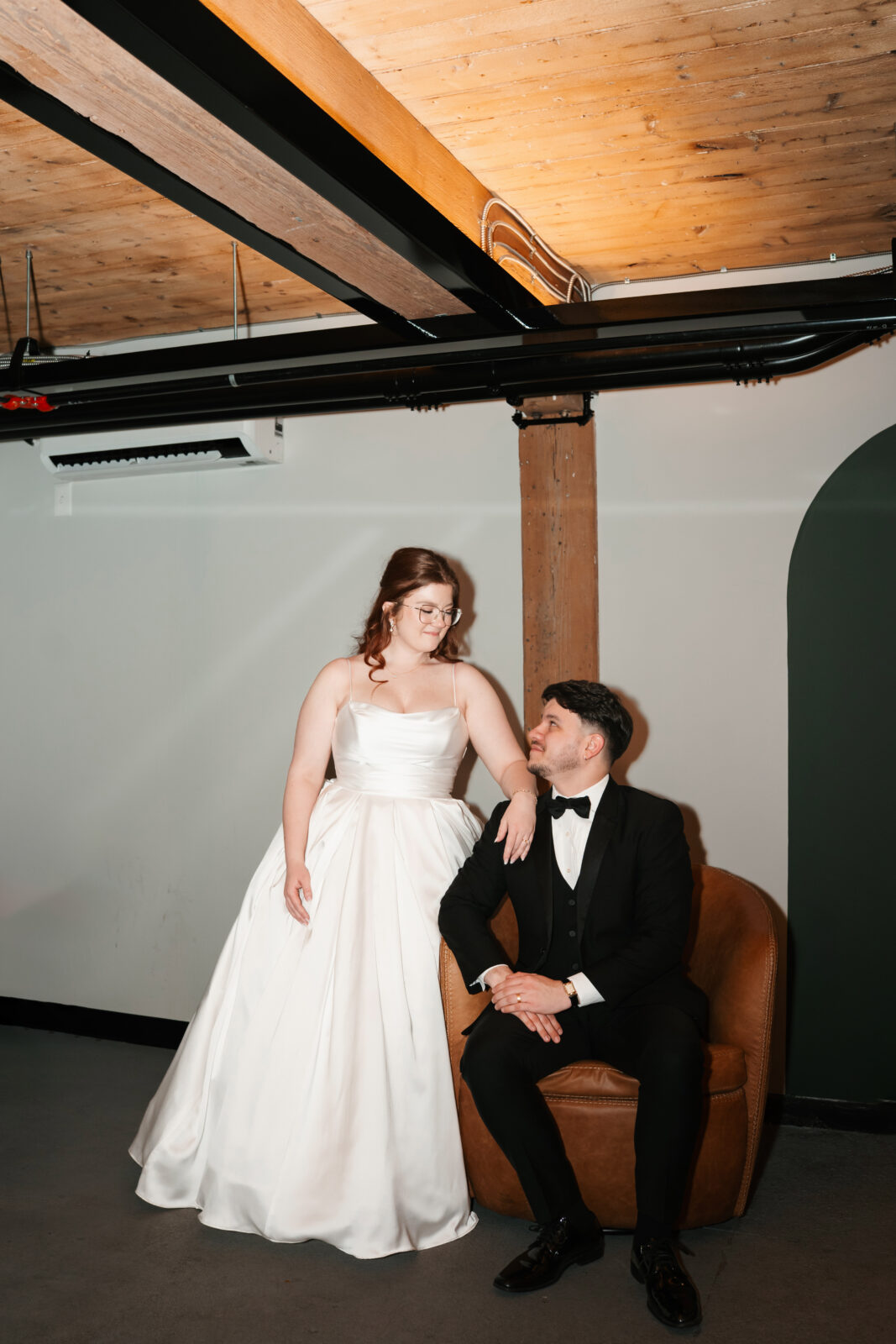 Industrial-chic wedding portraits of Emily and Nate inside The Venues at the Factory.