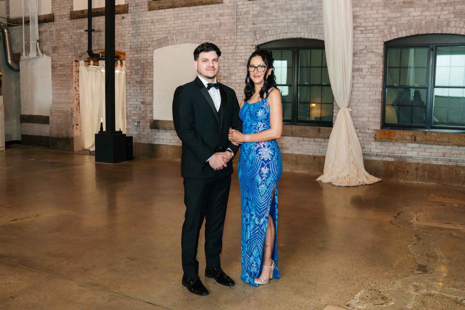 Wedding party and family portraits taken indoors at The Venues at the Factory on a rainy day.