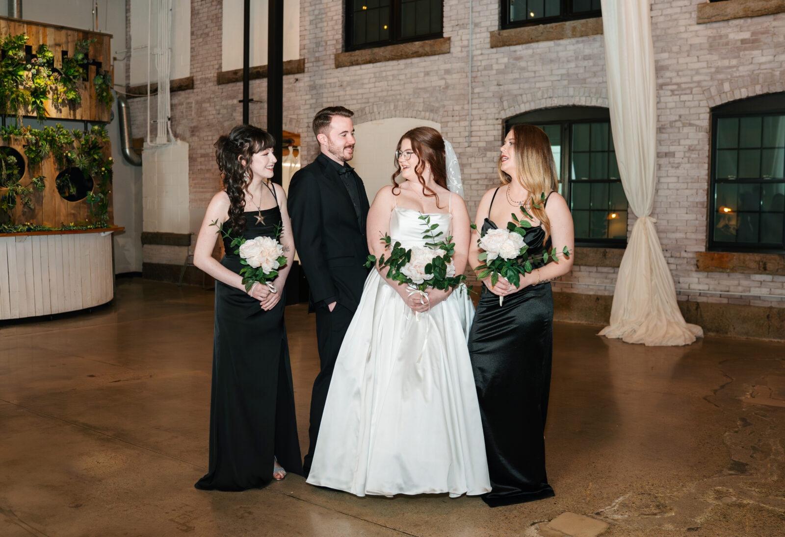 Wedding party and family portraits taken indoors at The Venues at the Factory on a rainy day.