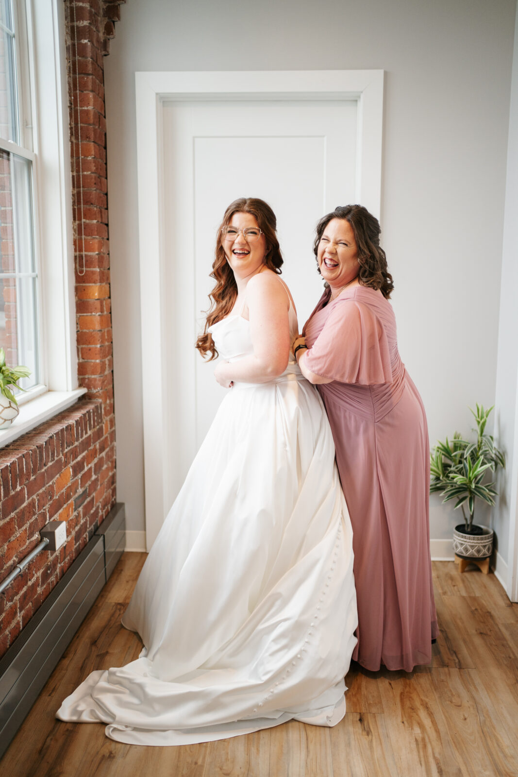 Bride getting ready in Airbnb suite inside The Venues at the Factory with natural light and elegant details.