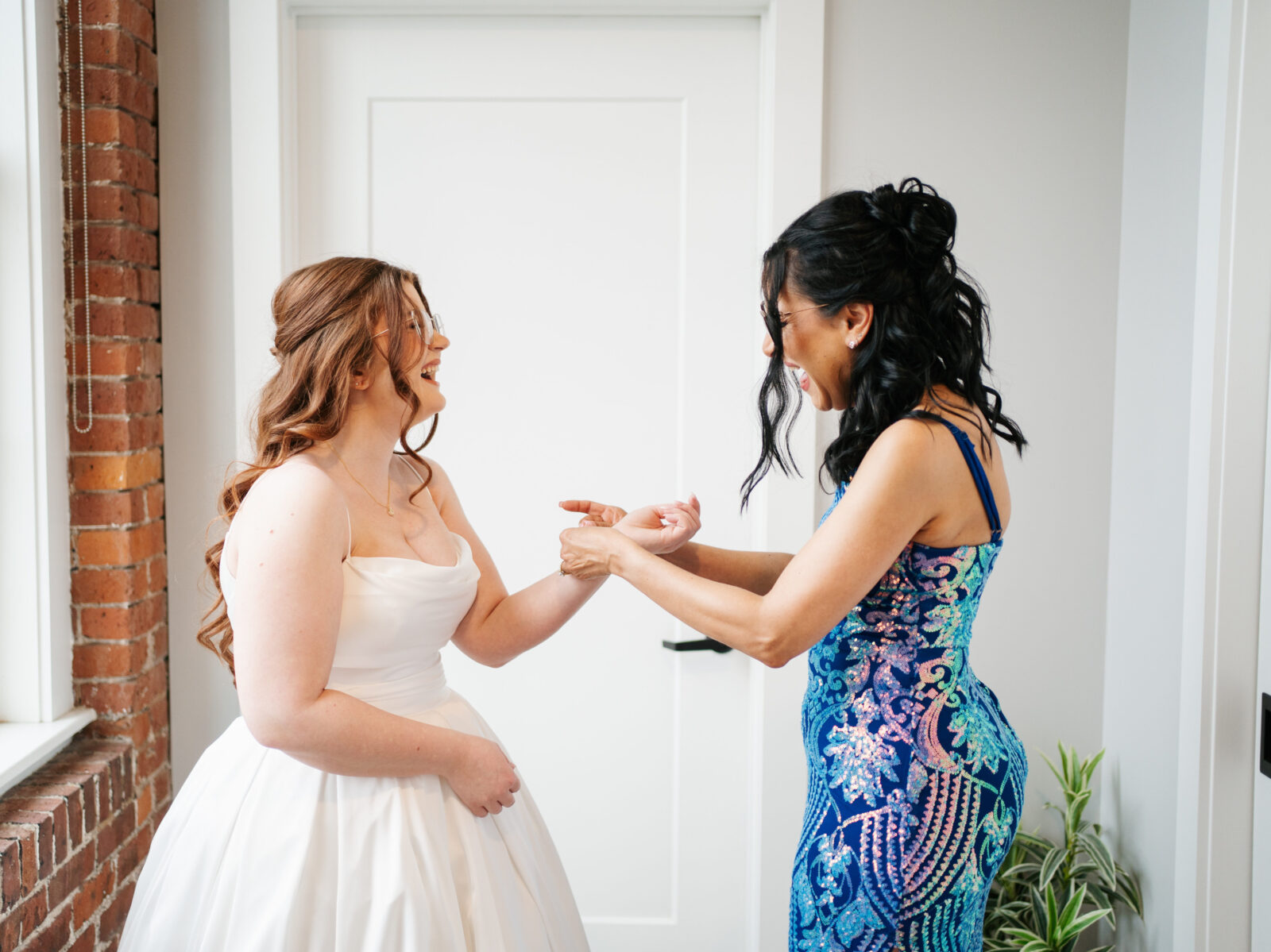 Bride getting ready in Airbnb suite inside The Venues at the Factory with natural light and elegant details.