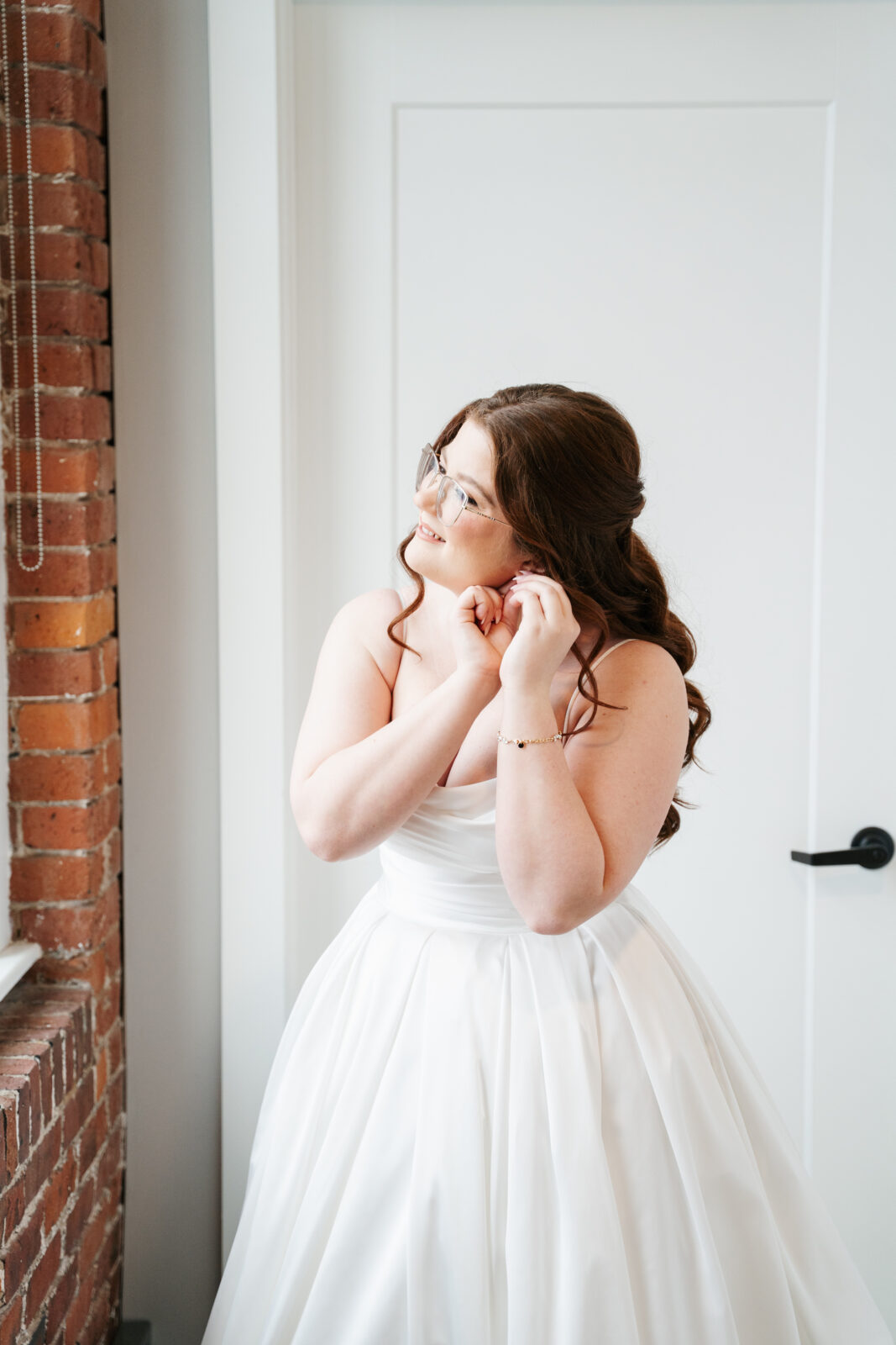 Bride getting ready in Airbnb suite inside The Venues at the Factory with natural light and elegant details.