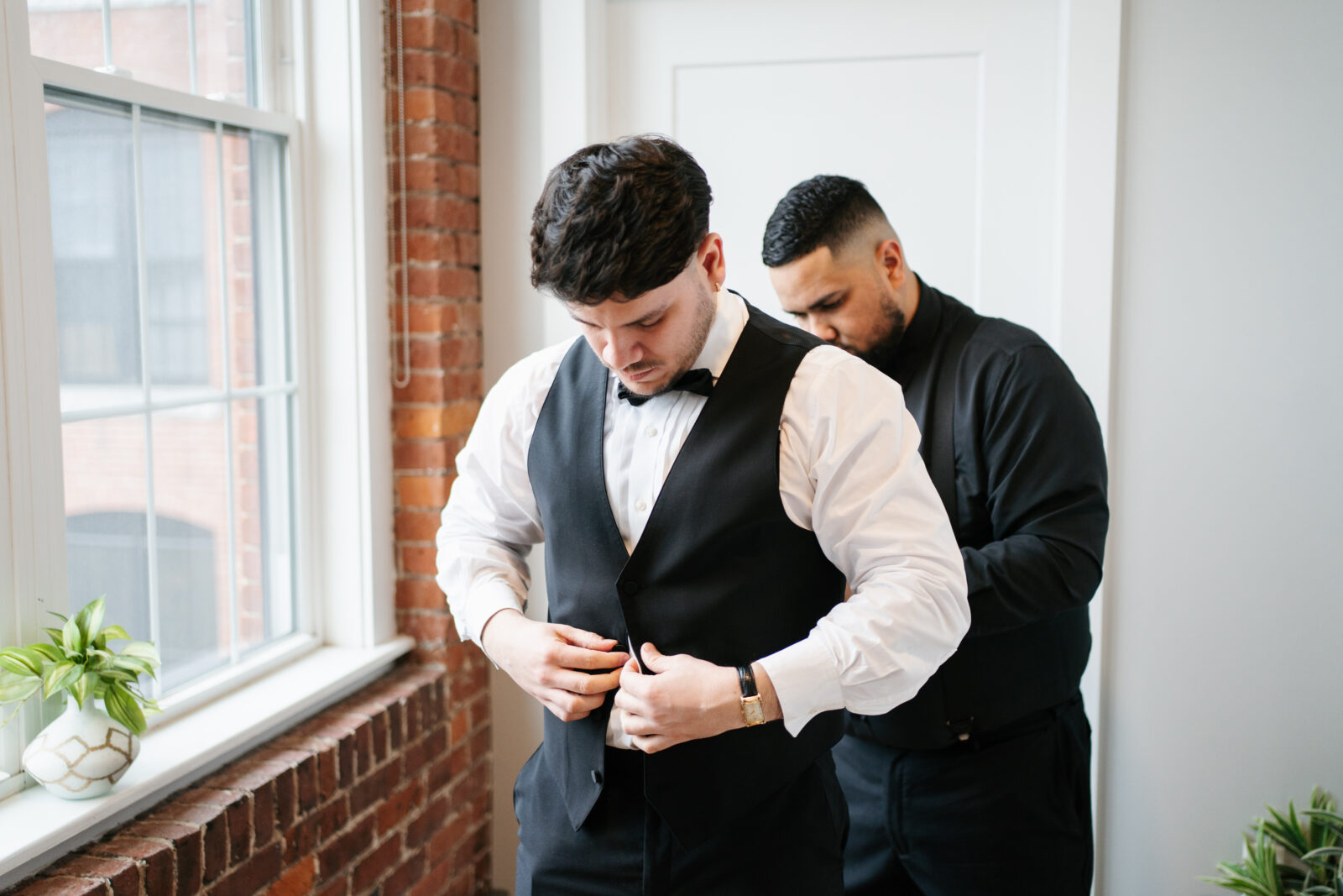 Bride getting ready in Airbnb suite inside The Venues at the Factory with natural light and elegant details.