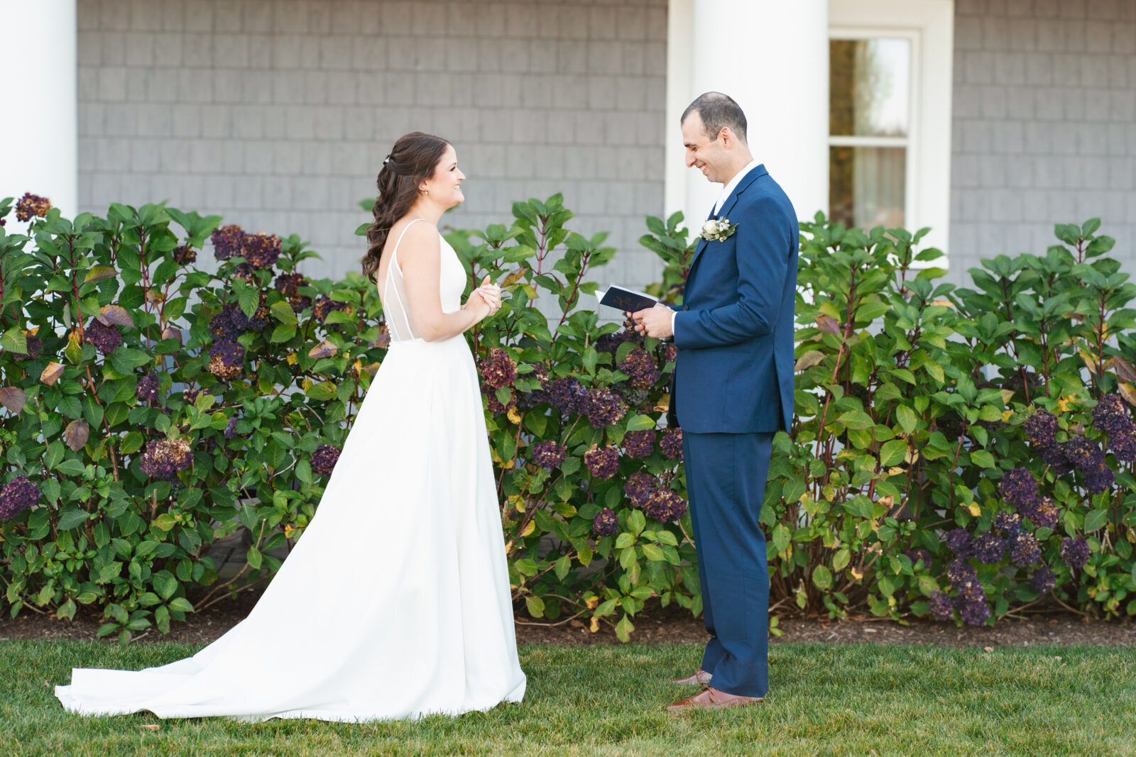 Bride and groom reading private vows in a quiet moment before the ceremony at Waverly Oaks in Plymouth, MA.