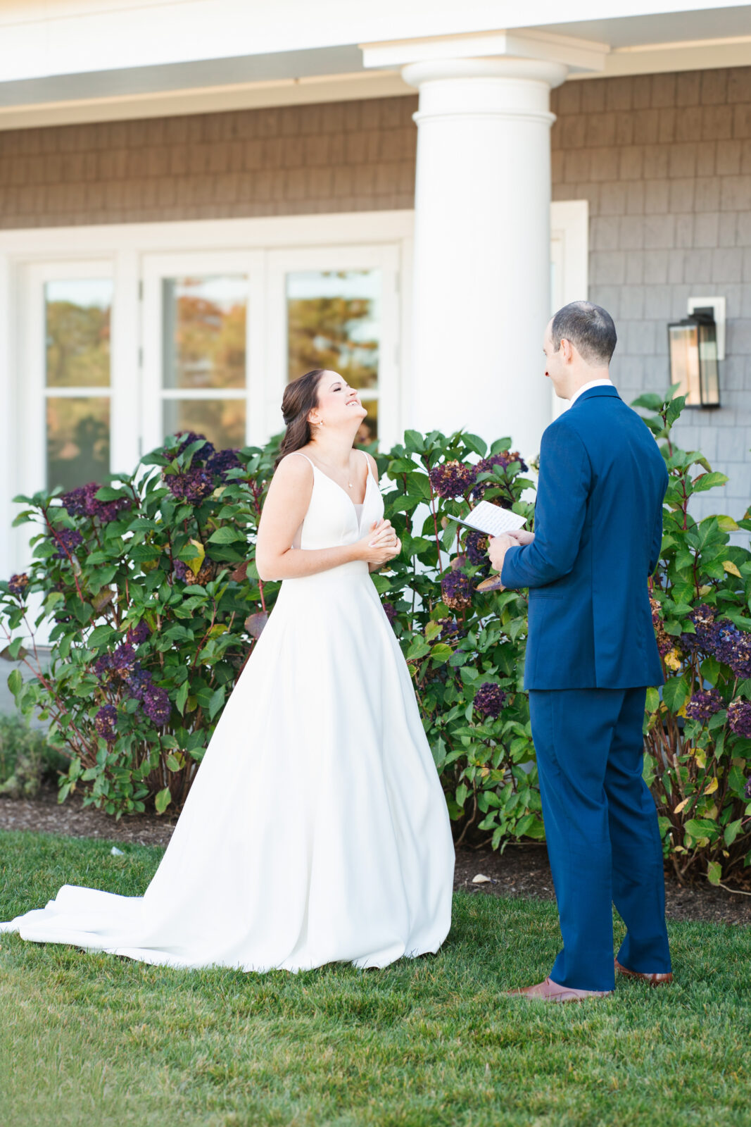 Bride and groom reading private vows in a quiet moment before the ceremony at Waverly Oaks in Plymouth, MA.