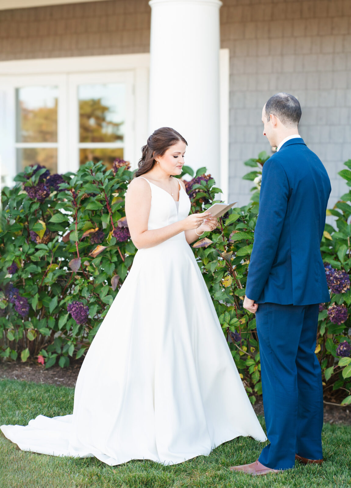 Bride and groom reading private vows in a quiet moment before the ceremony at Waverly Oaks in Plymouth, MA.