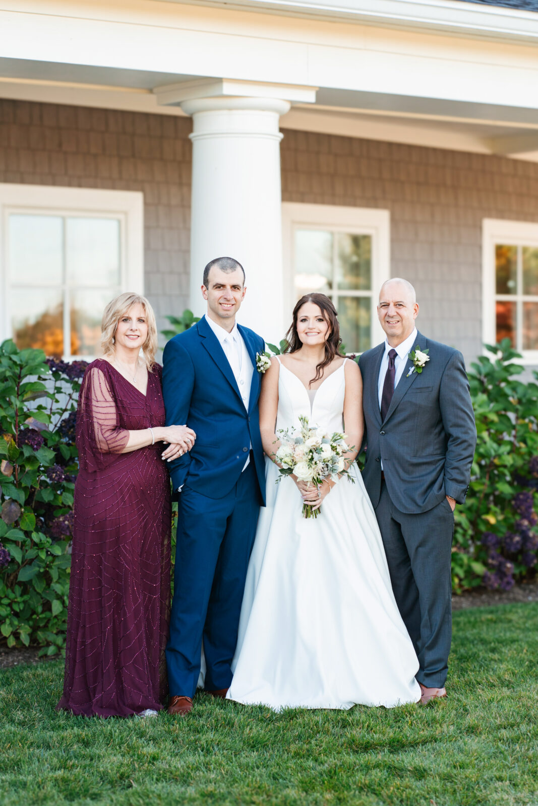 Bridal party celebrating with the couple on the lawn at Waverly Oaks in Plymouth, MA