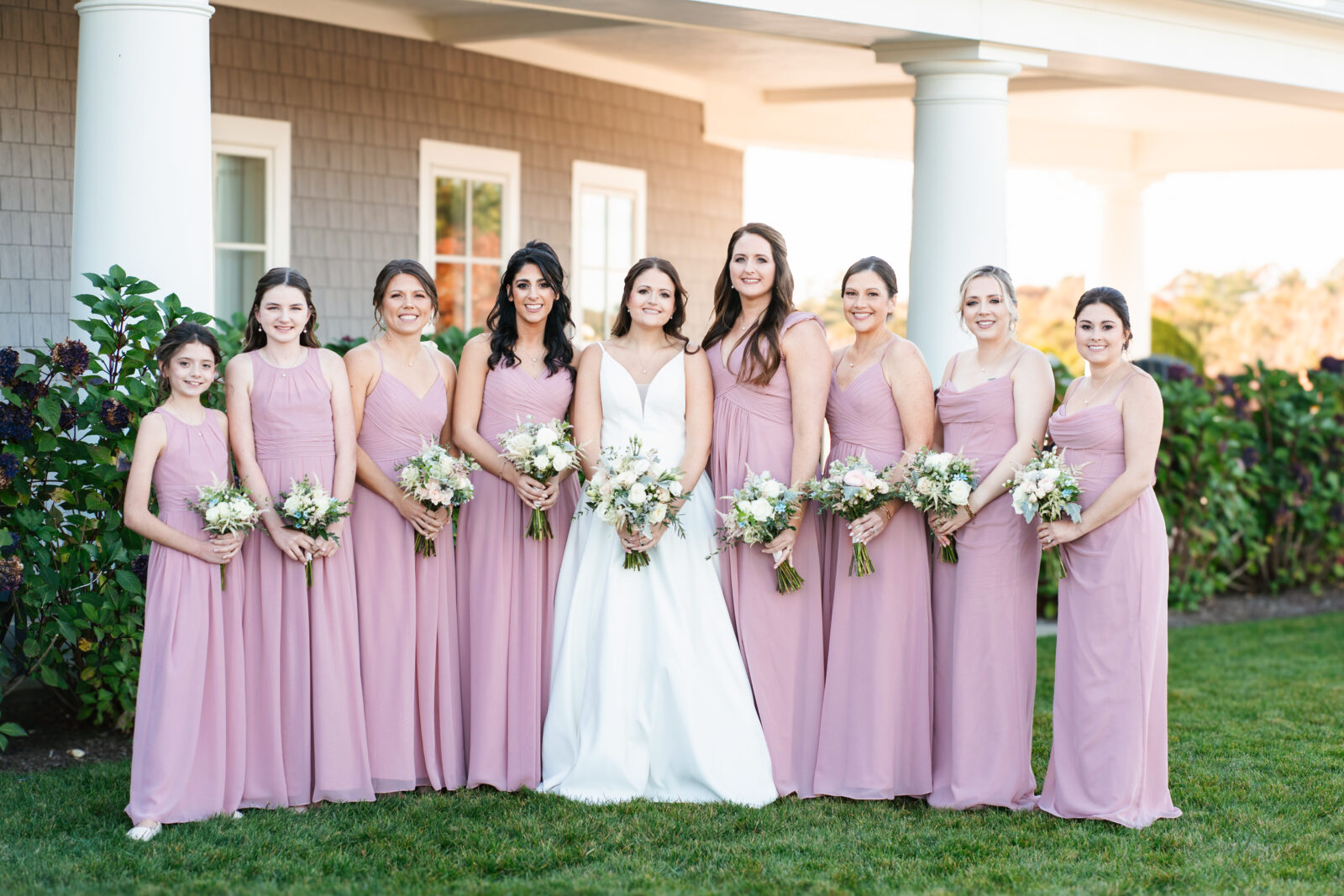 Bridal party celebrating with the couple on the lawn at Waverly Oaks in Plymouth, MA