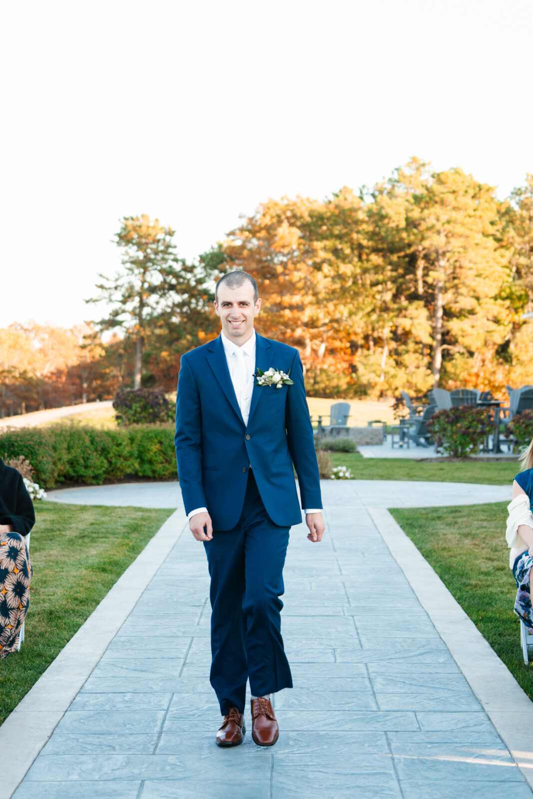 Elegant outdoor wedding ceremony at Waverly Oaks in Plymouth, MA with lush greenery and classic white chairs.