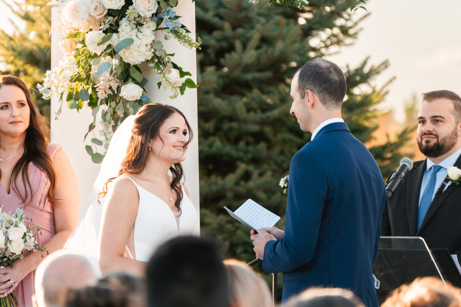 Elegant outdoor wedding ceremony at Waverly Oaks in Plymouth, MA with lush greenery and classic white chairs.