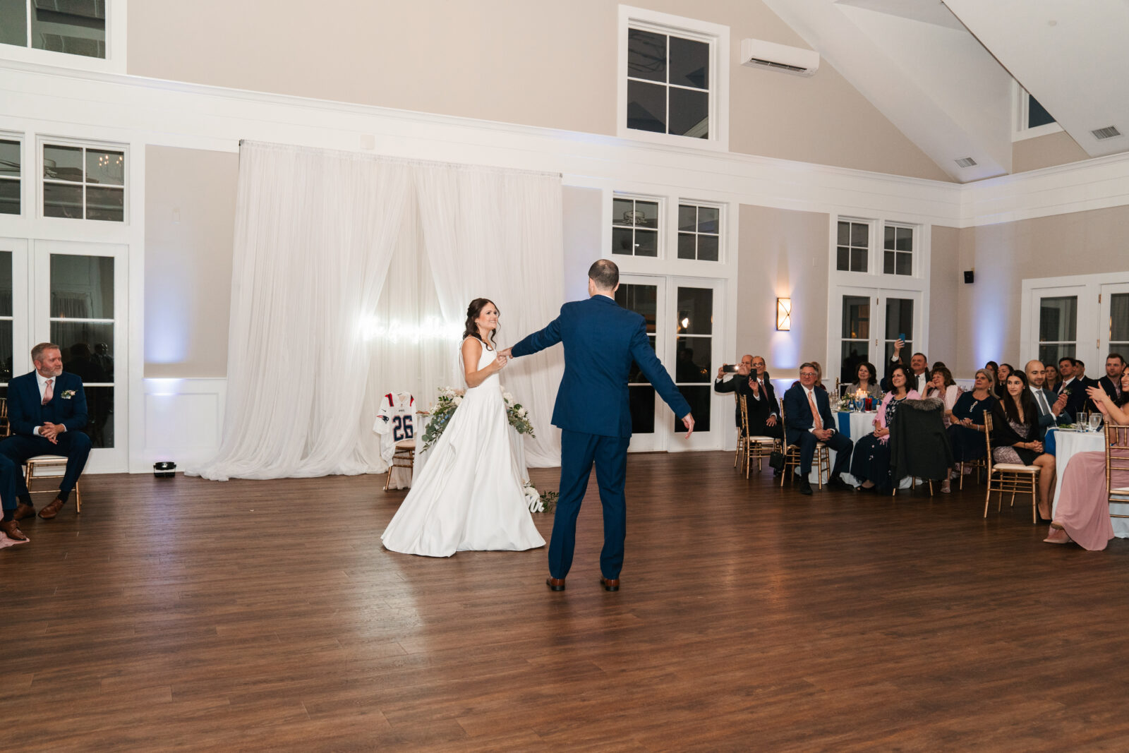 Romantic wedding reception setup at Waverly Oaks in Plymouth, MA with string lights and floral centerpieces.