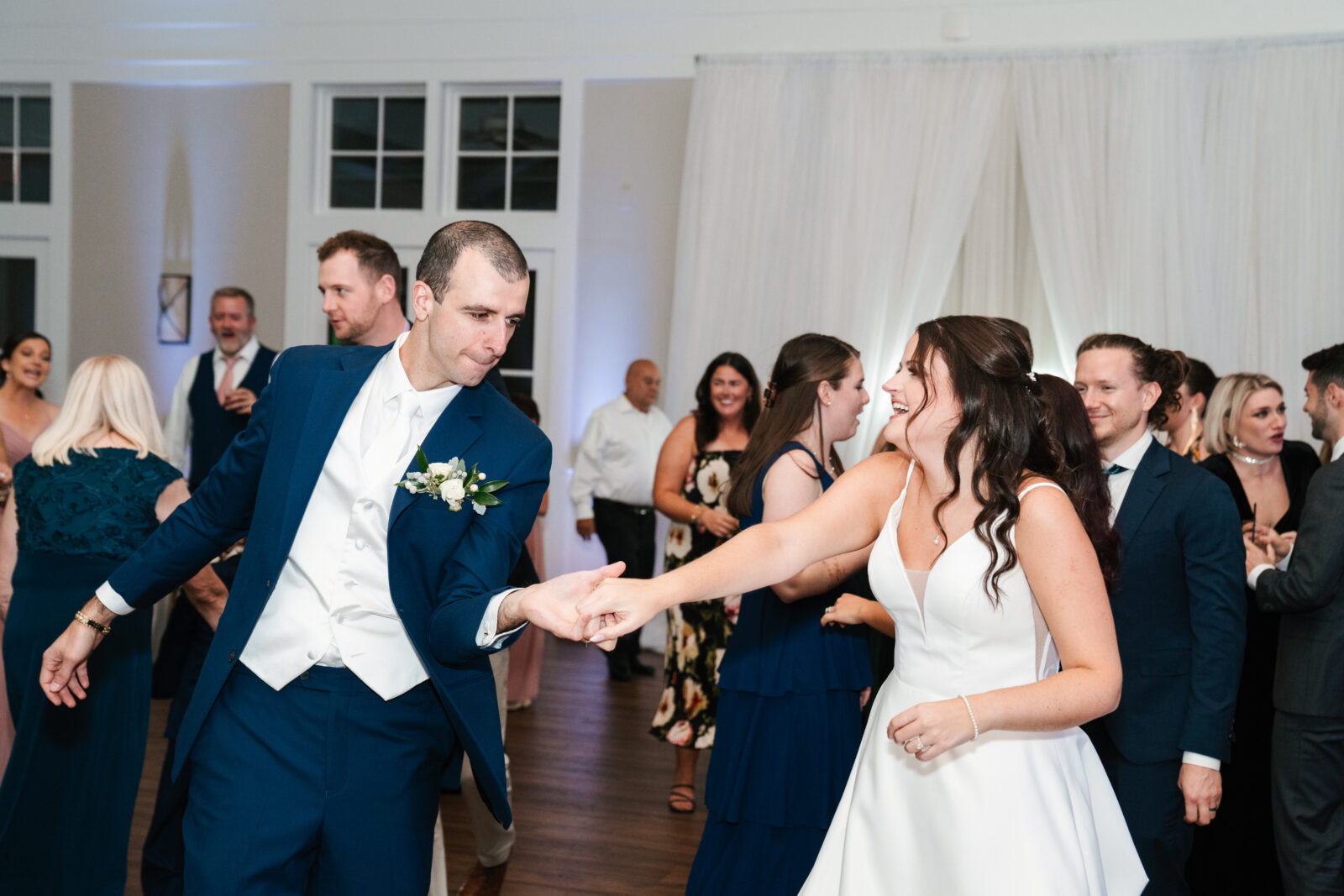 Romantic wedding reception setup at Waverly Oaks in Plymouth, MA with string lights and floral centerpieces.