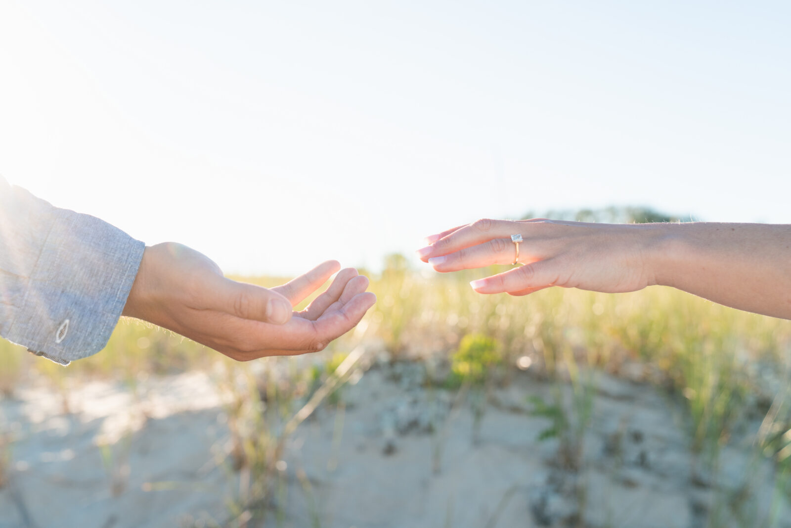 Sunset engagement portraits captured on a quiet New England beach.