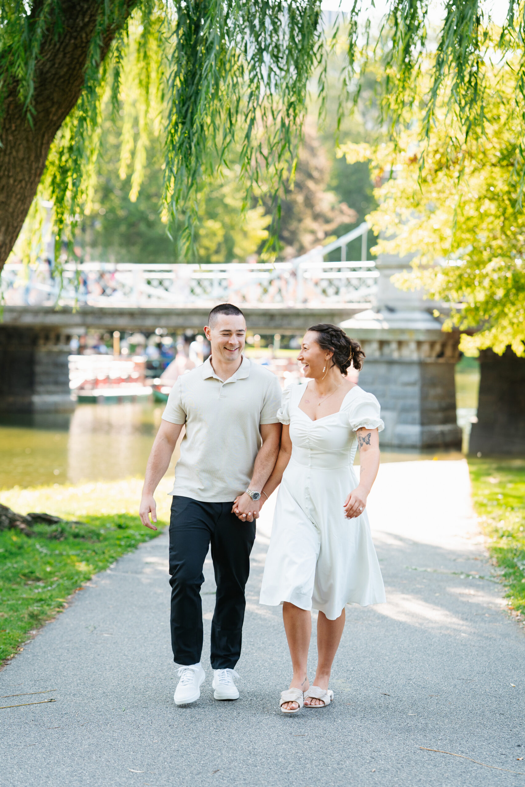 Couple embracing near classic Boston brownstones during their engagement shoot.