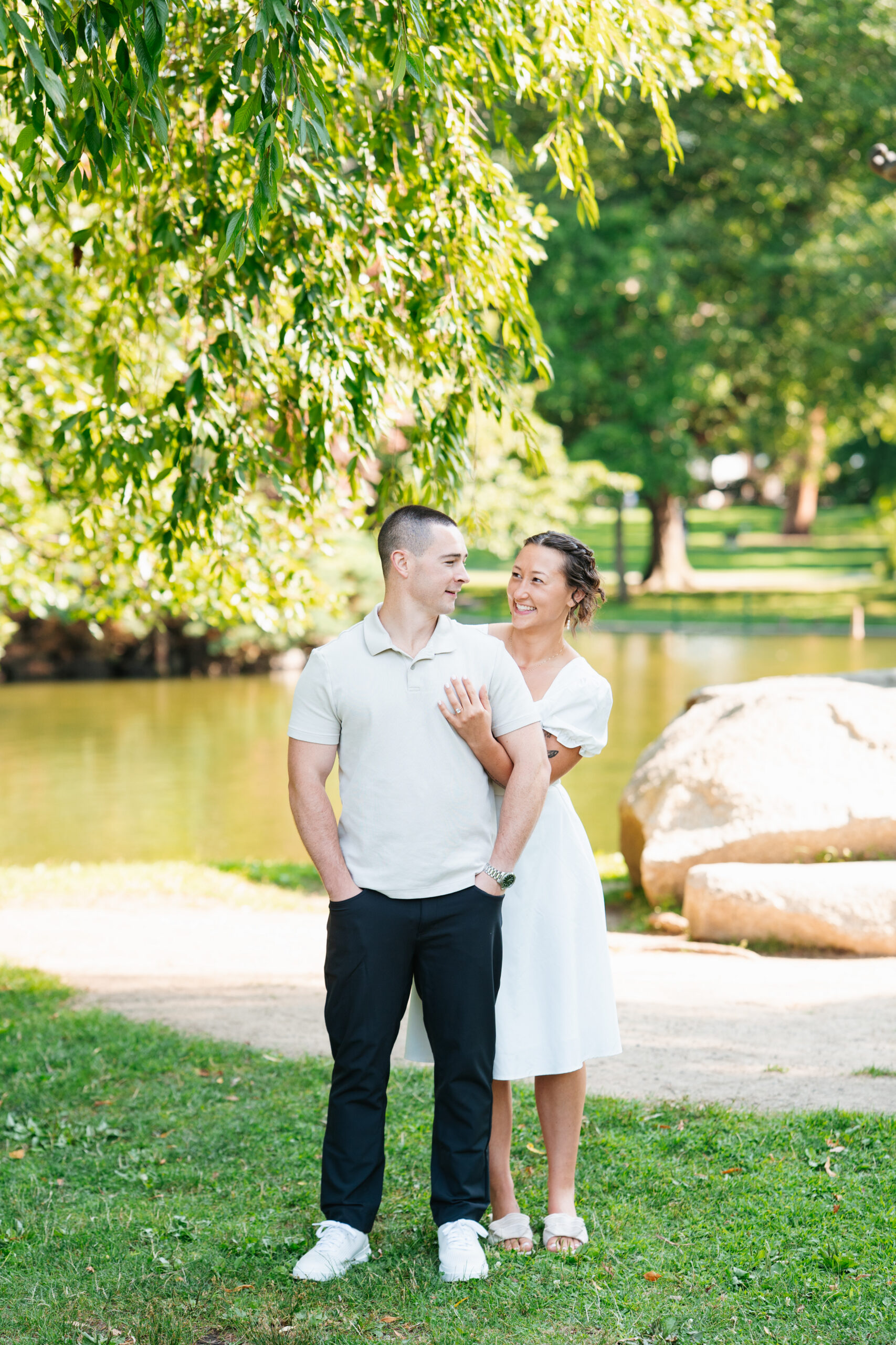 Couple sitting together on city steps during a relaxed engagement session in Boston.