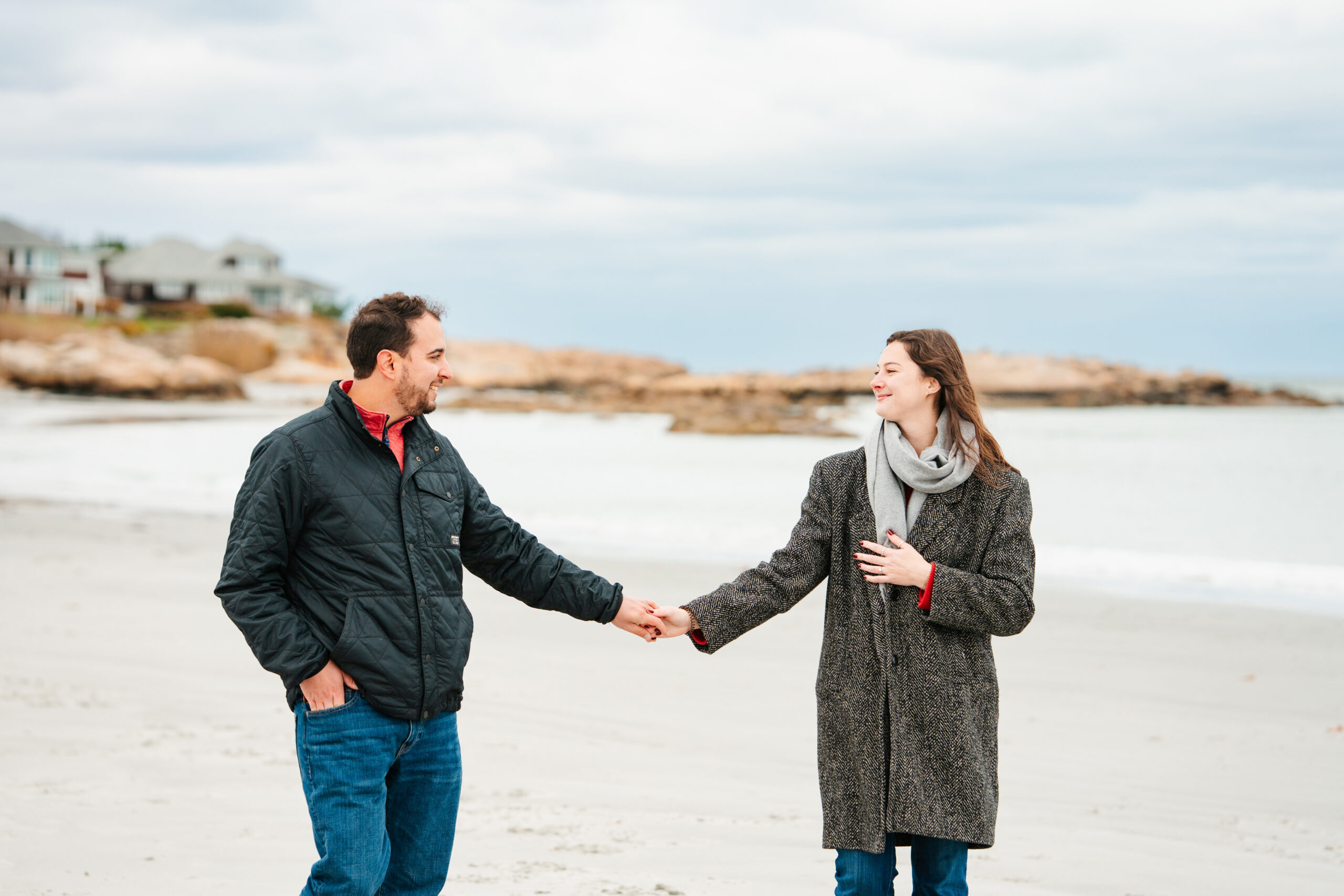 engagement photos being taking on the beach