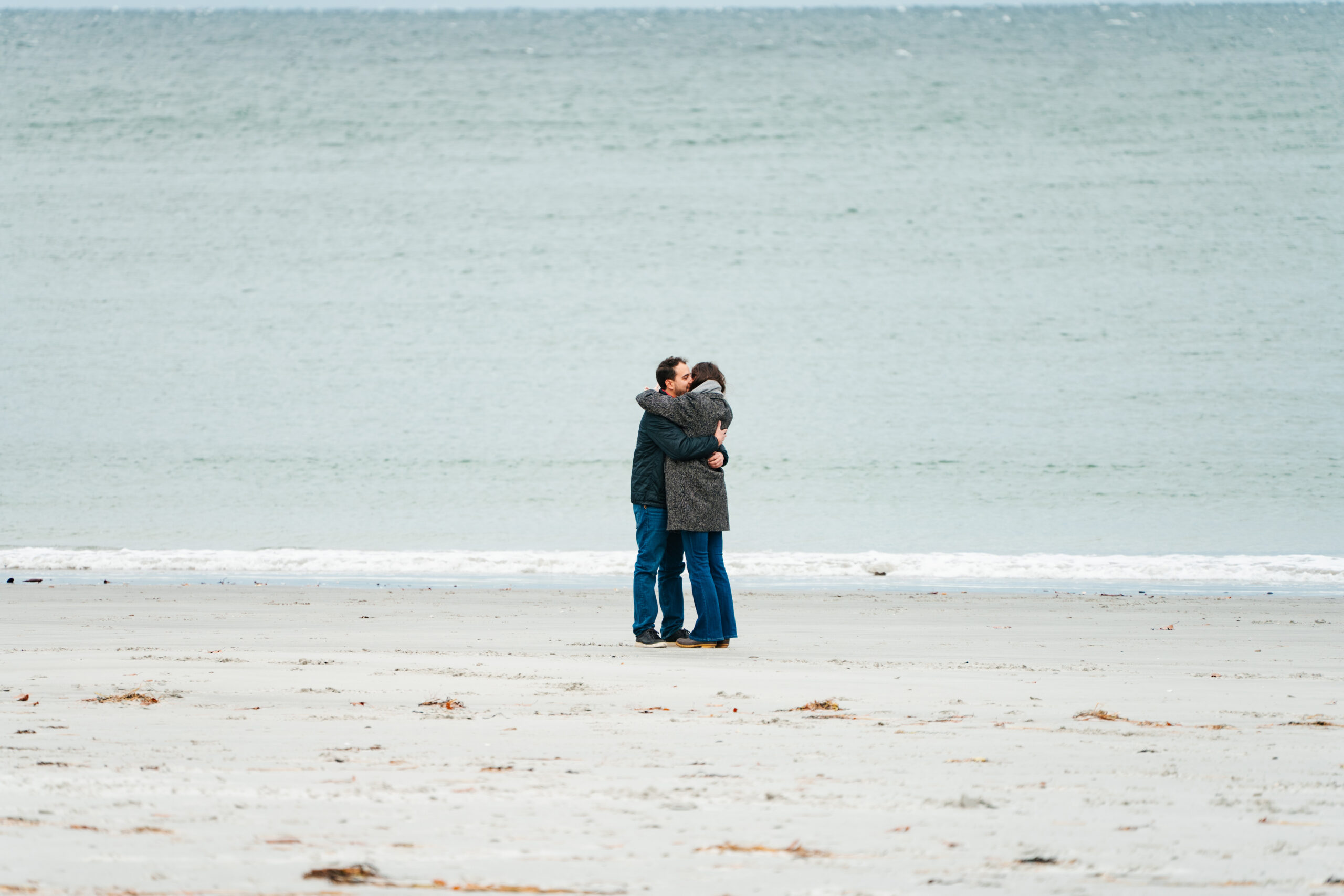 moment right after couple gets engaged on the beach