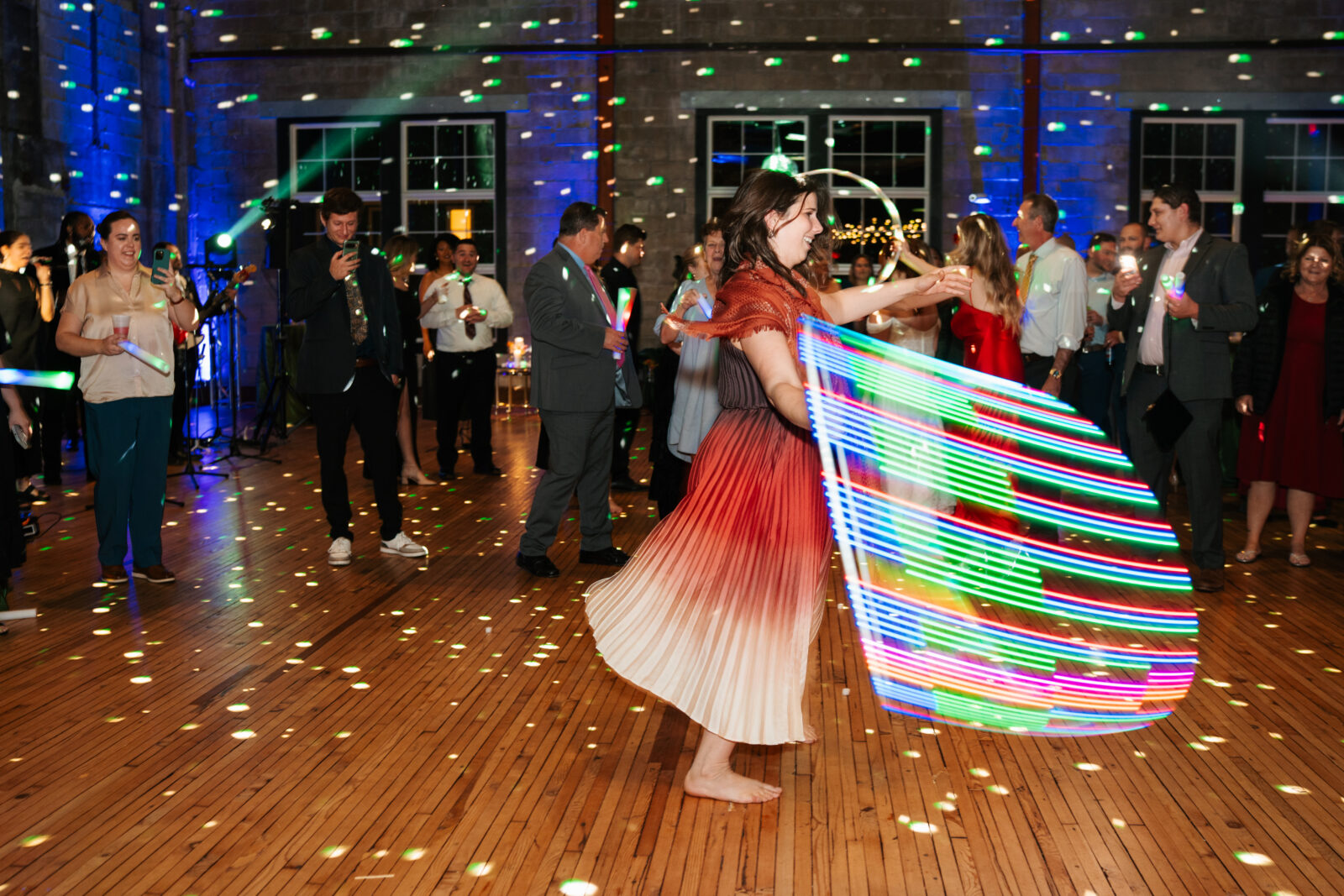 Guests using hula hoops on the dance floor at Olio wedding